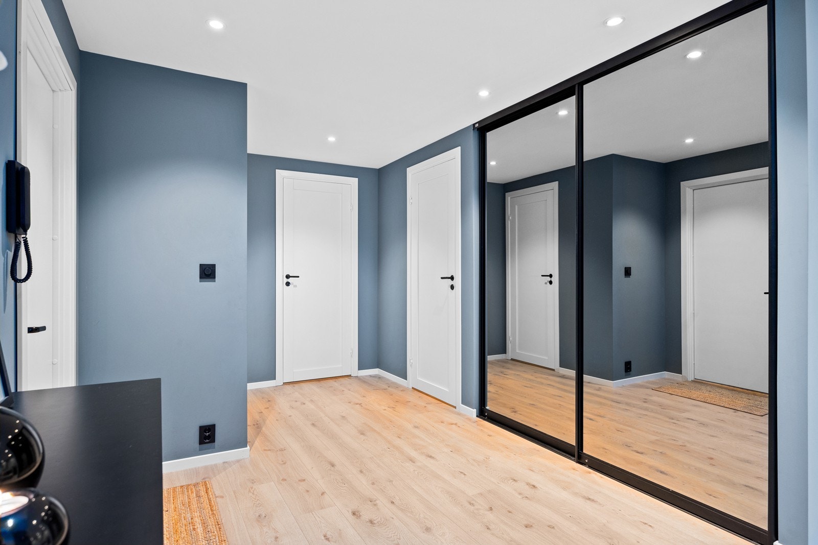 Skyvedørsgarderobe med speilfronter i gangen gir rikelig med oppbevaringsplass. Galleribilde
