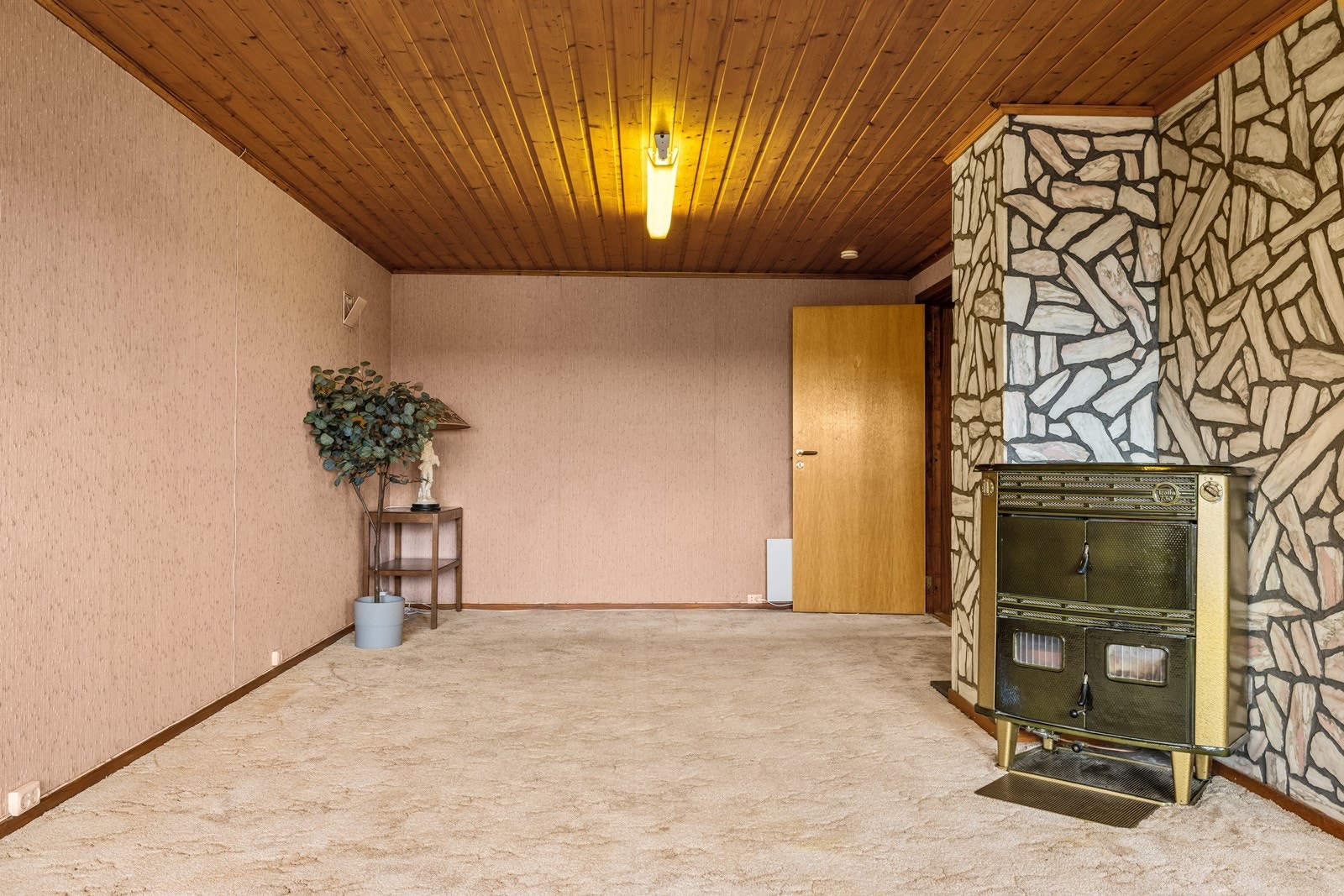 Også i denne stuen er det en kombinert kamin/vedovn. Galleribilde