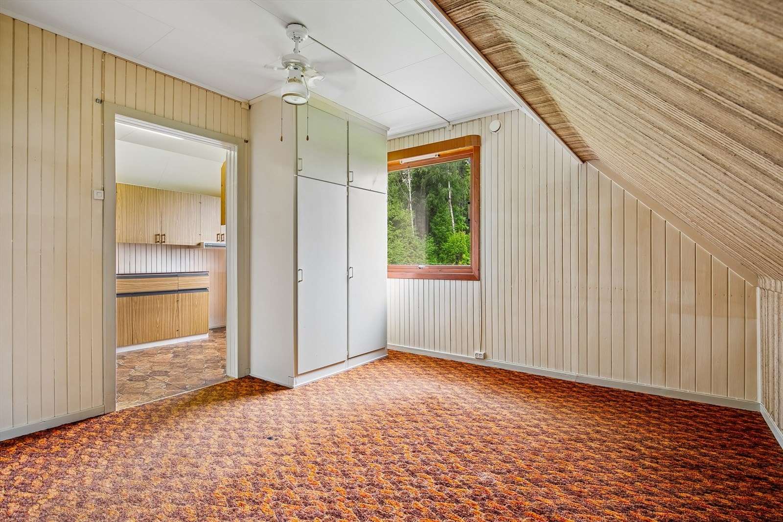 Det andre soverommet i etasjen har garderobeskap og panel på veggene. Galleribilde