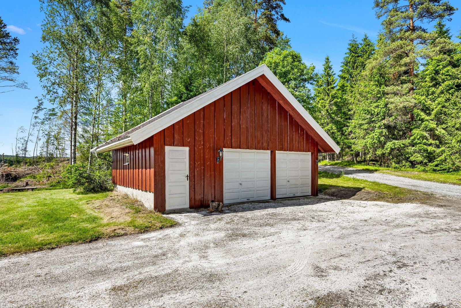 På tomten står det også en frittstående garasje som gir praktisk oppbevaring og parkering. Galleribilde