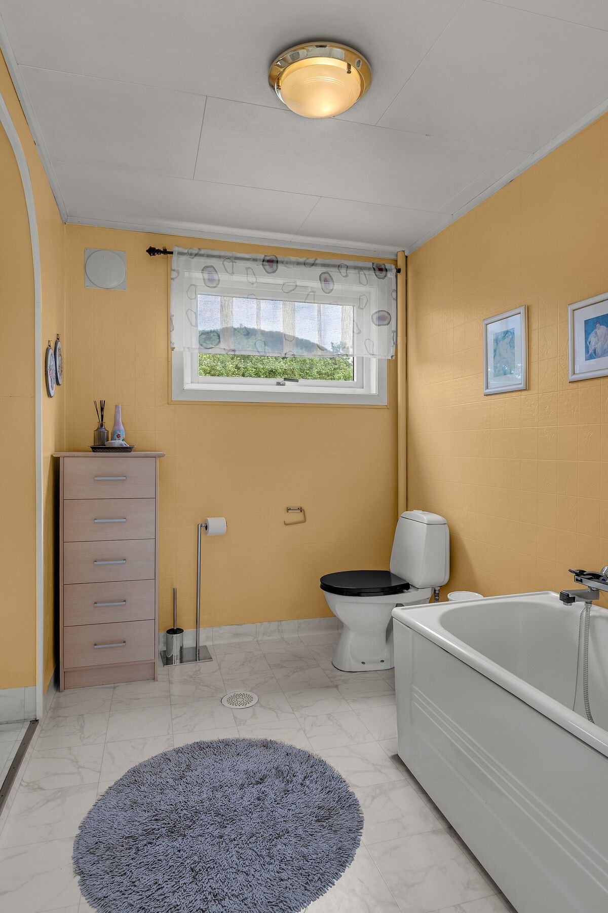 Badet i andre etasje er utstyrt med badekar og toalett. Overflatene består av vinylbelegg på gulv og malt våtromstapet. Galleribilde
