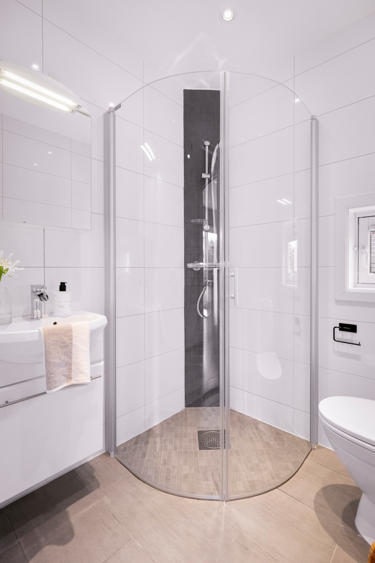 I 2. etasje finner du også et ekstra bad. Badet er innredet med lyse fliser, toalett, servantinnredning og dusjnisje med glassdører. Galleribilde