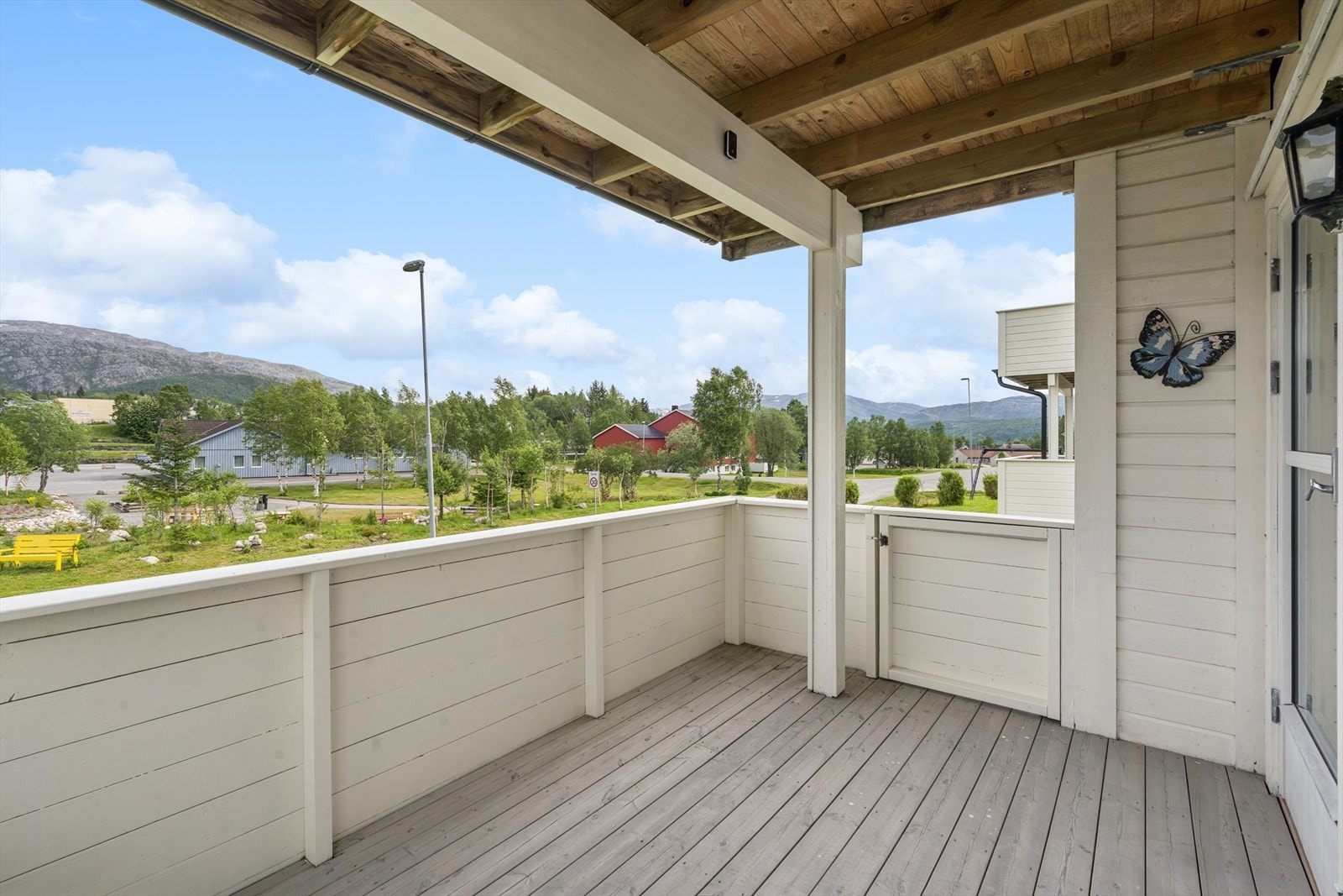 Terrassen måler ca. 8 m² og har et malt tett rekkverk med adkomst fra både hagen og stuen. Galleribilde