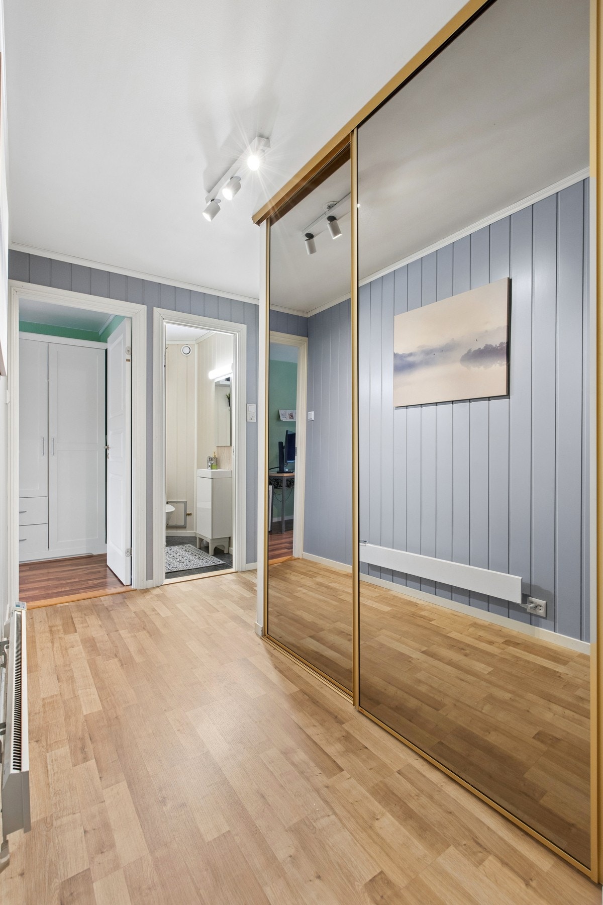 Gangen i underetasjen har en romslig skyvedørsgarderobe for ekstra oppbevaring. Galleribilde