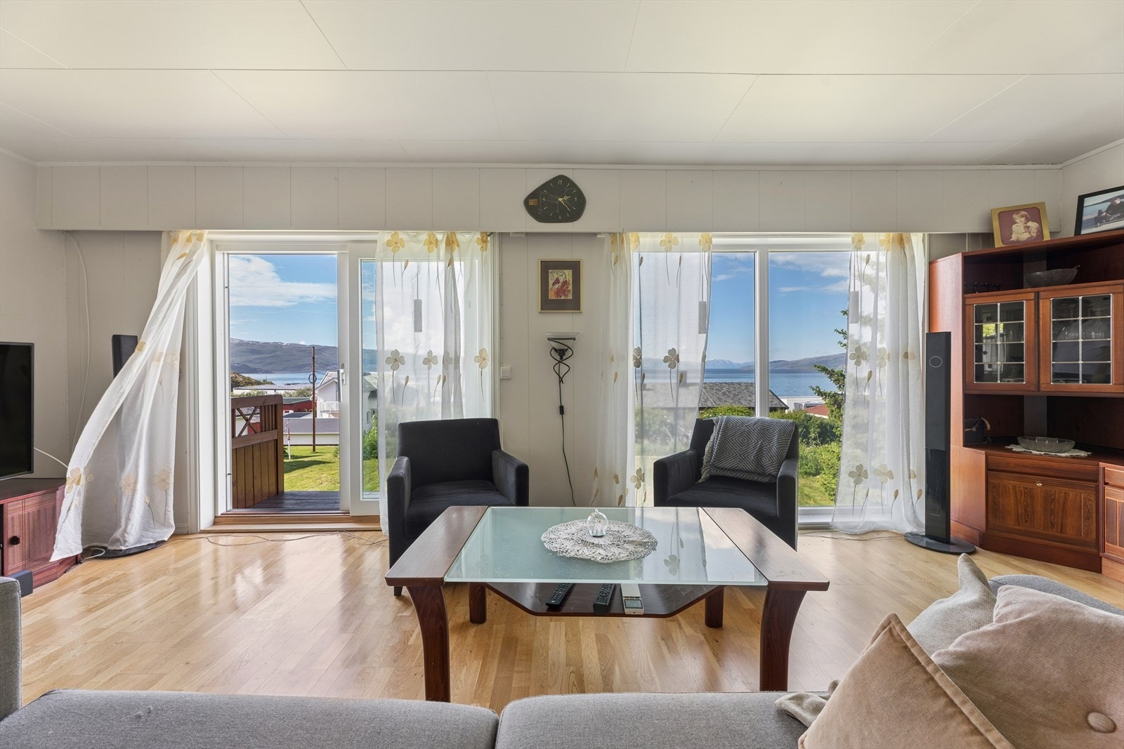 Stuen har store vindusflater og skyvedør som åpner opp mot hagen og utsikten. Galleribilde