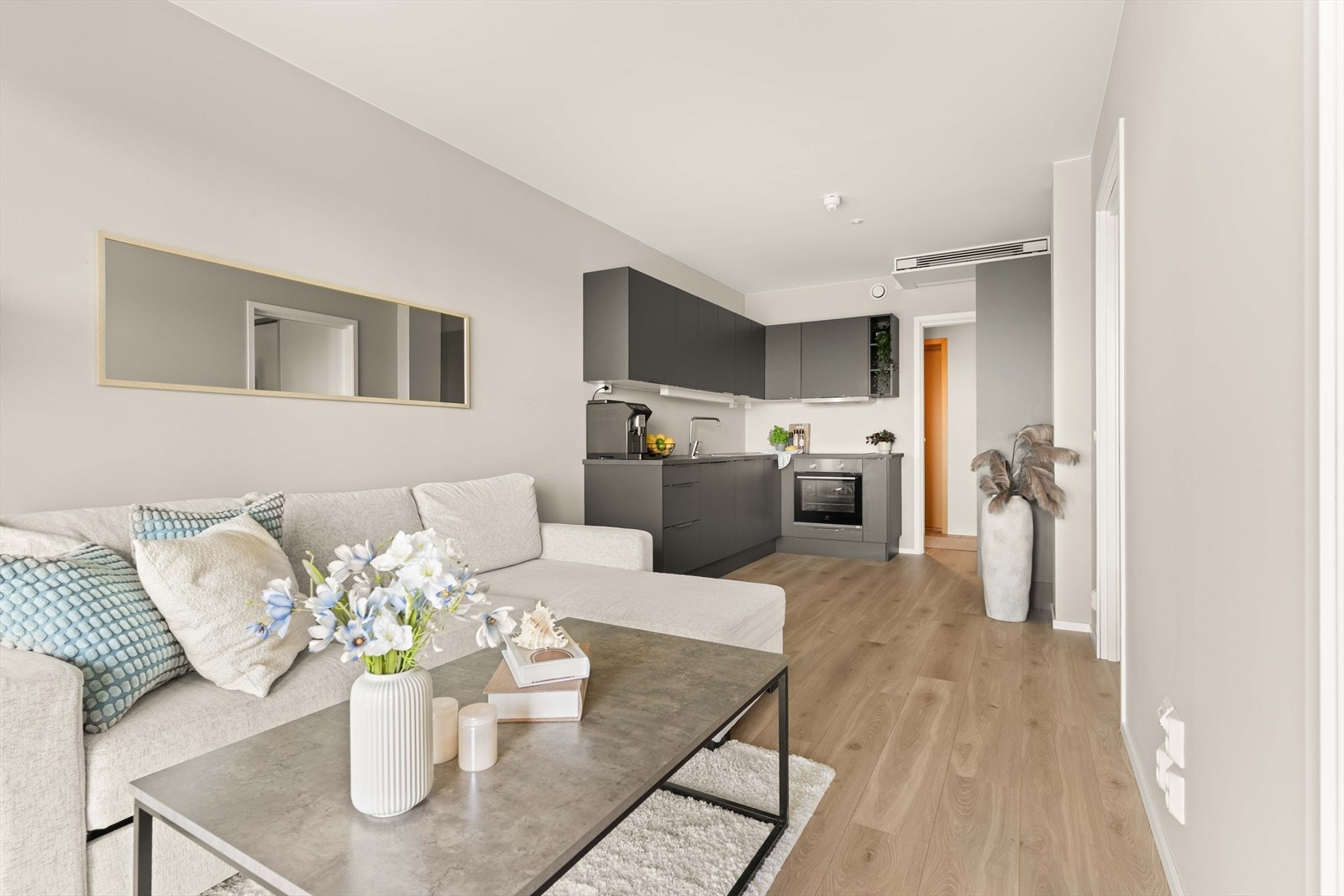 Stilren oppholdsdel med plass til både avslapning og sosiale soner. Lyse overflater og moderne innredning gir et innbydende helhetsinntrykk. Galleribilde