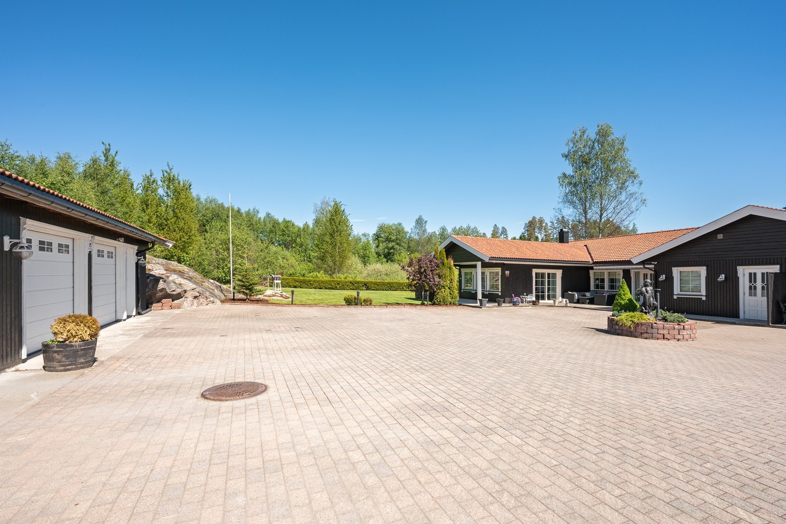 Den store gårdsplassen er steinbelagt. Gårdsplassen deles med naboen. Galleribilde
