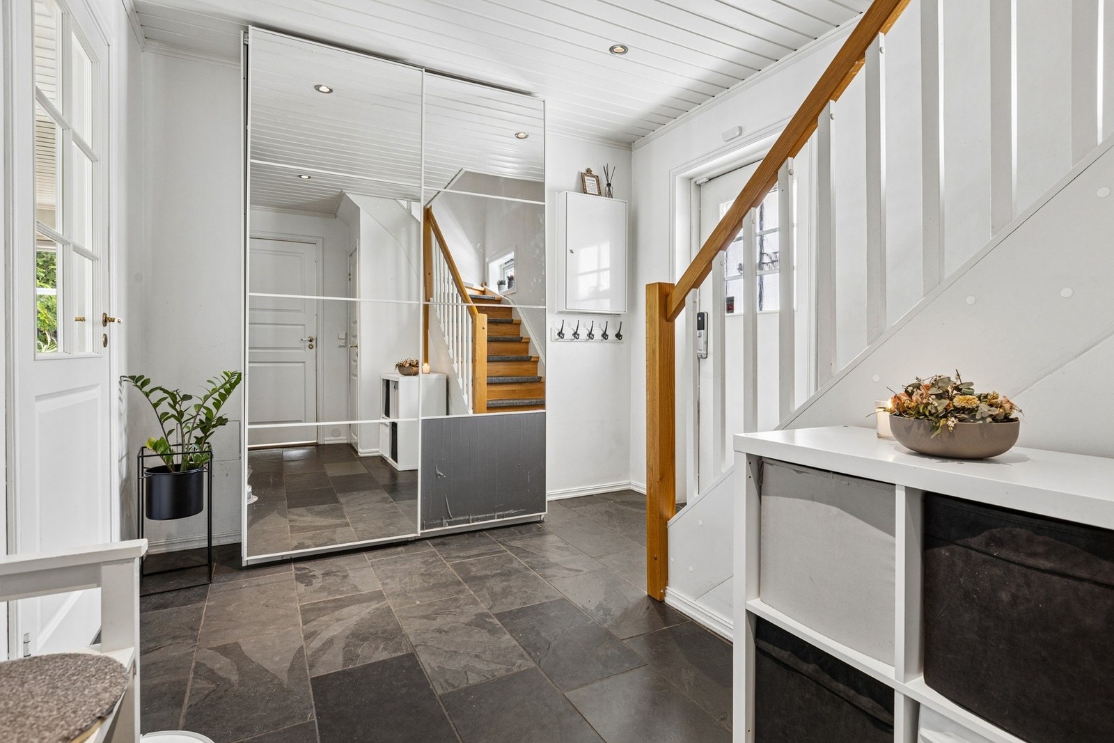 Boligen ønskes velkommen inn i en lys og praktisk entré med god plass til oppbevaring av yttertøy og sko. Galleribilde