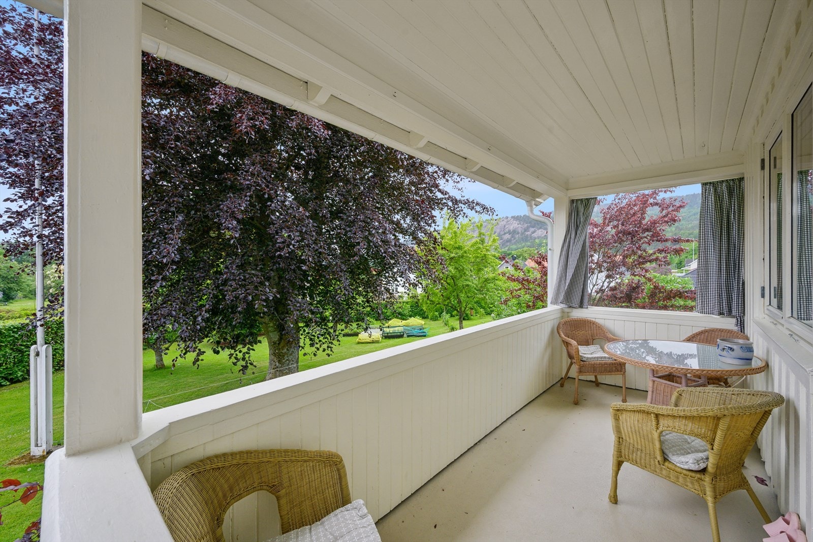 Overbygd terrasse med plass til sittegruppe. Herfra er det trapp ned til hagen. Galleribilde