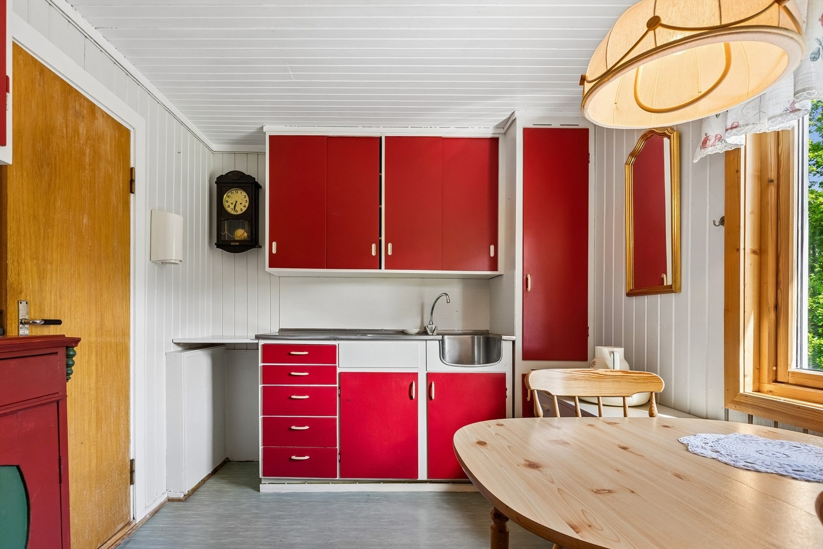 Kjøkkenet i andre etasje har en enkel innredning med slette, malte fronter og benkeplate i rustfritt stål. Galleribilde