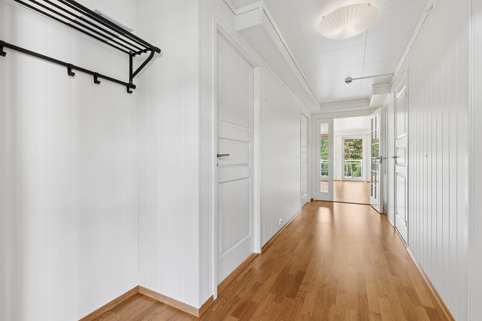 Entréen har gulv med parkett og vegger med panel, og gir tilgang til øvrige rom i boligen. Galleribilde