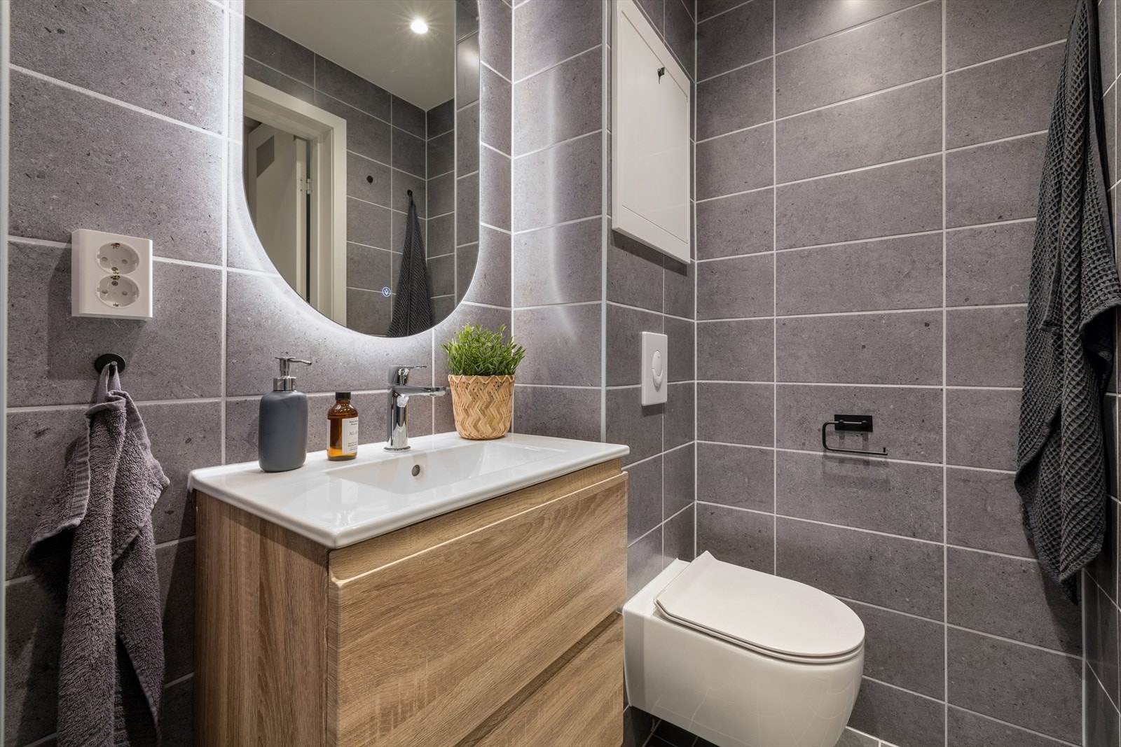 Badet er videre utstyrt med vegghengt toalett, downlightsbelysning og varmekabler i gulv Galleribilde