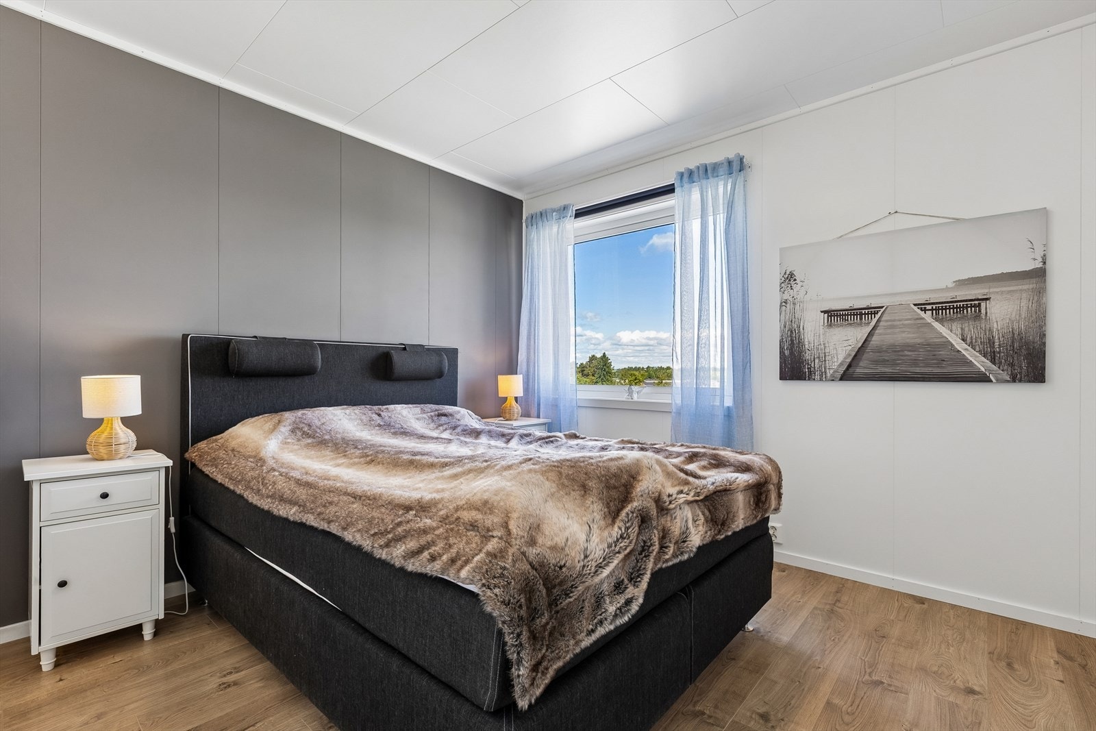 Soverommet har malte plater på veggene og laminat på gulvet, en gjennomgående stil i etasjen. Galleribilde