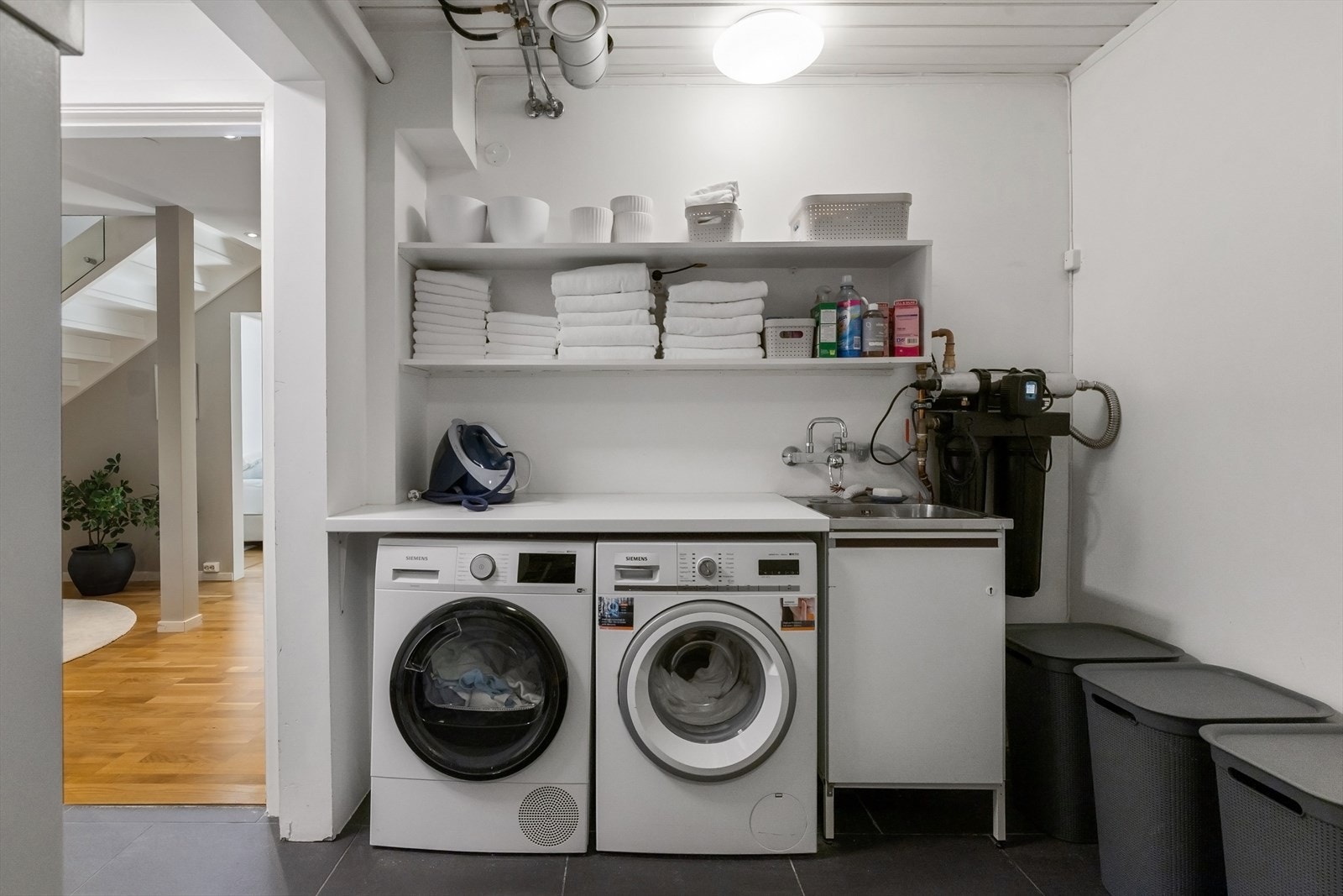 Praktisk og funksjonelt vaskerom pusset opp i 2009/2010. Rommet er innredet med benkeplate, stål utslagsvask, hyller over arbeidsbenk og opplegg for både vaskemaskin og tørketrommel. Galleribilde