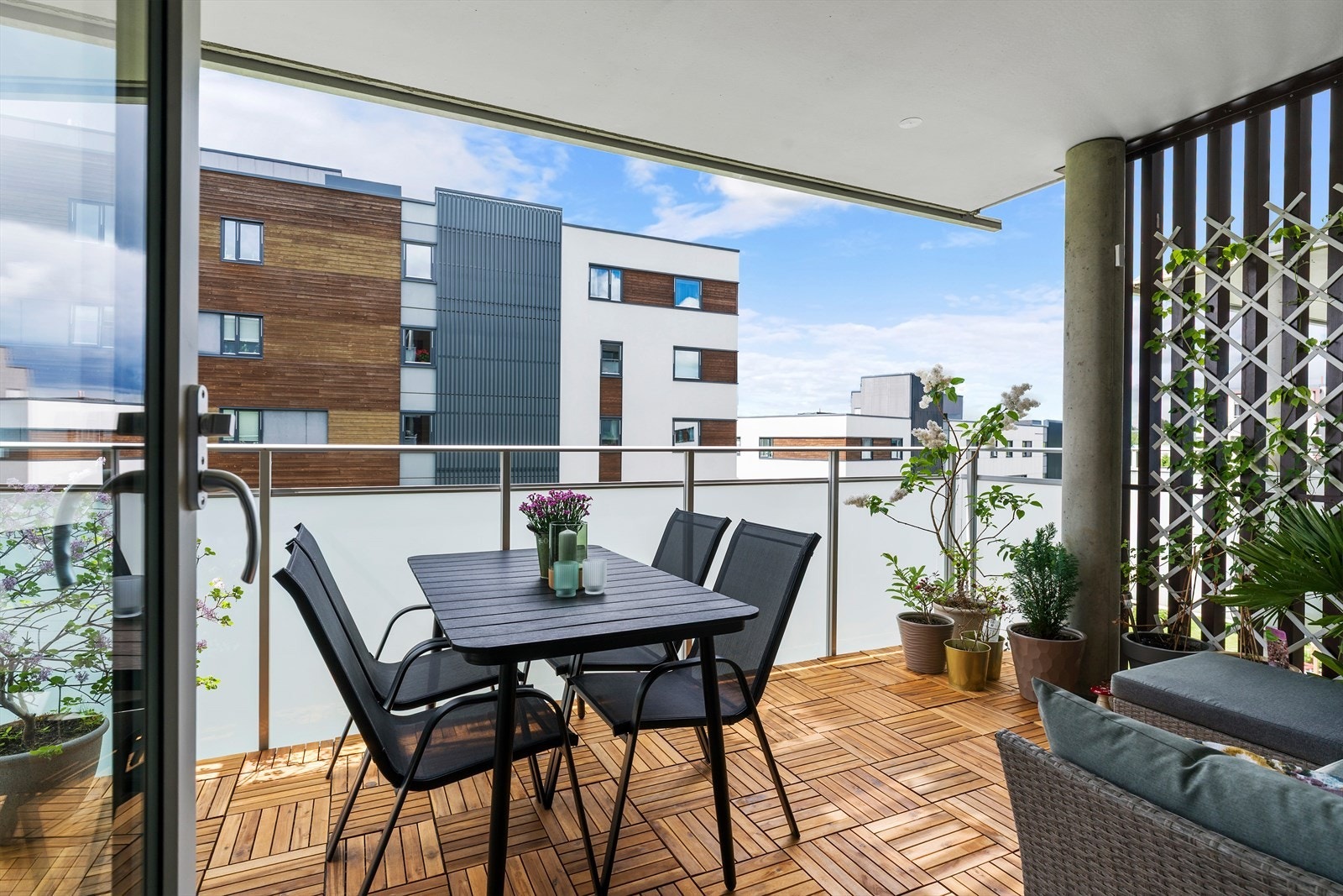 Balkongen har nye treheller på gulvet, overbygg, rekkverk i metall med frostet glass som begrenser innsyn. Galleribilde