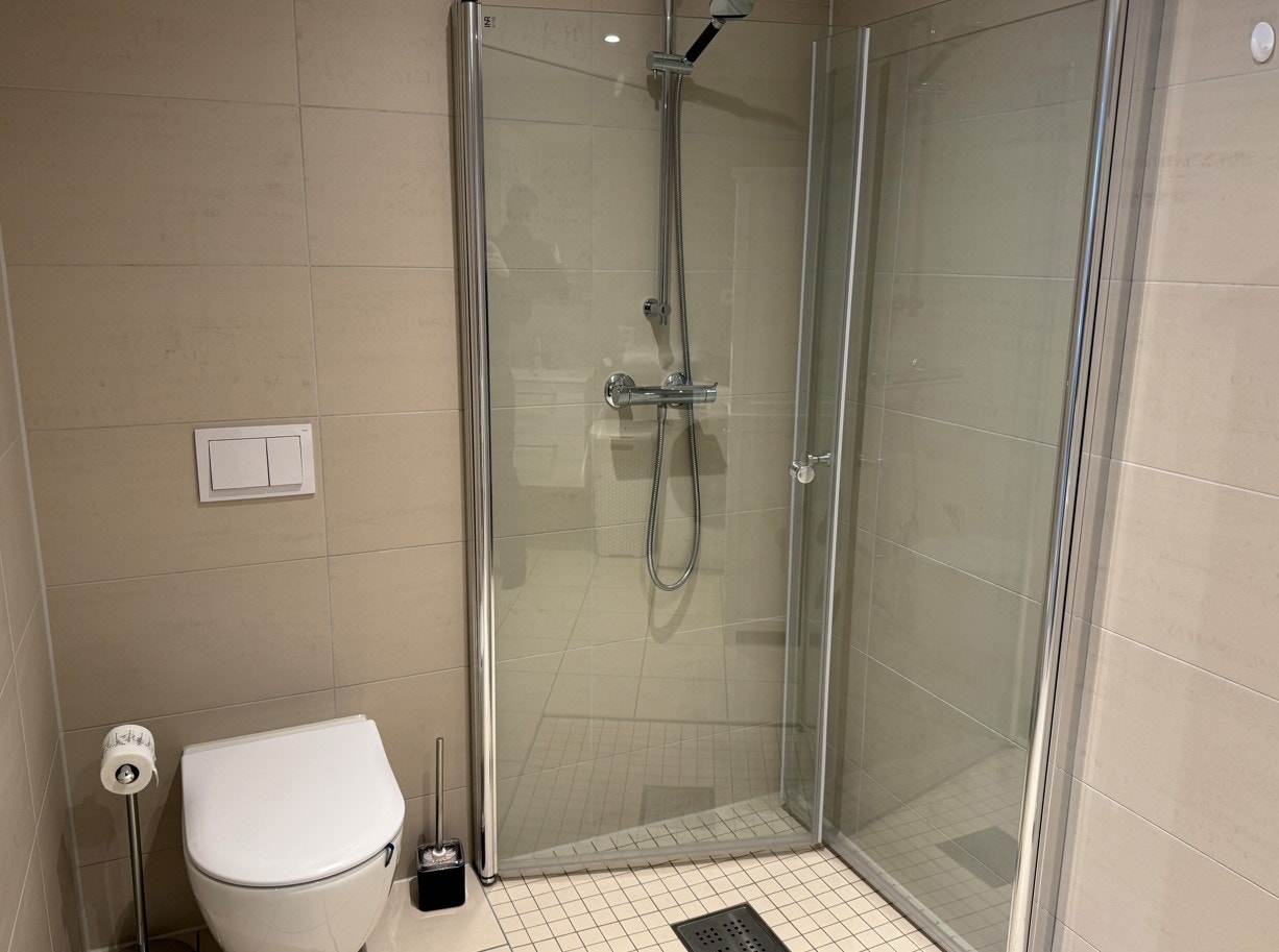Badet er romslig og moderne, med vegghengt toalett og dusjnisje. Galleribilde
