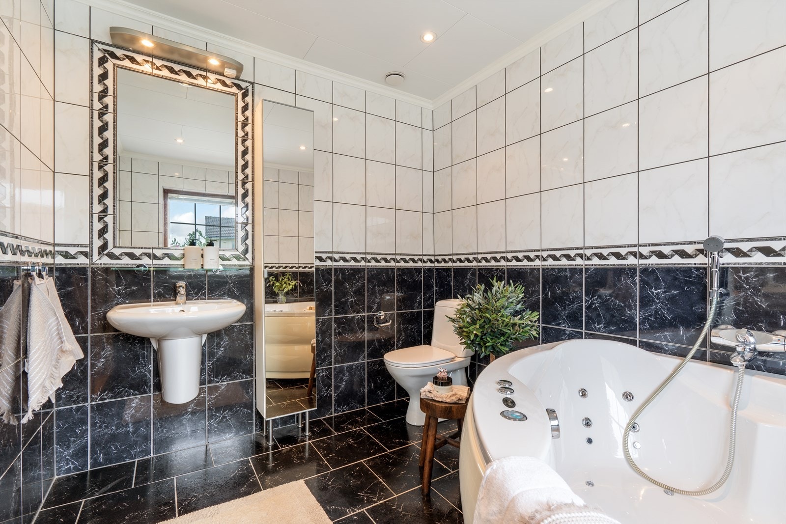 Badet i første etasje er flislagt og har gulvvarme. Rommet er utstyrt med badekar. Galleribilde