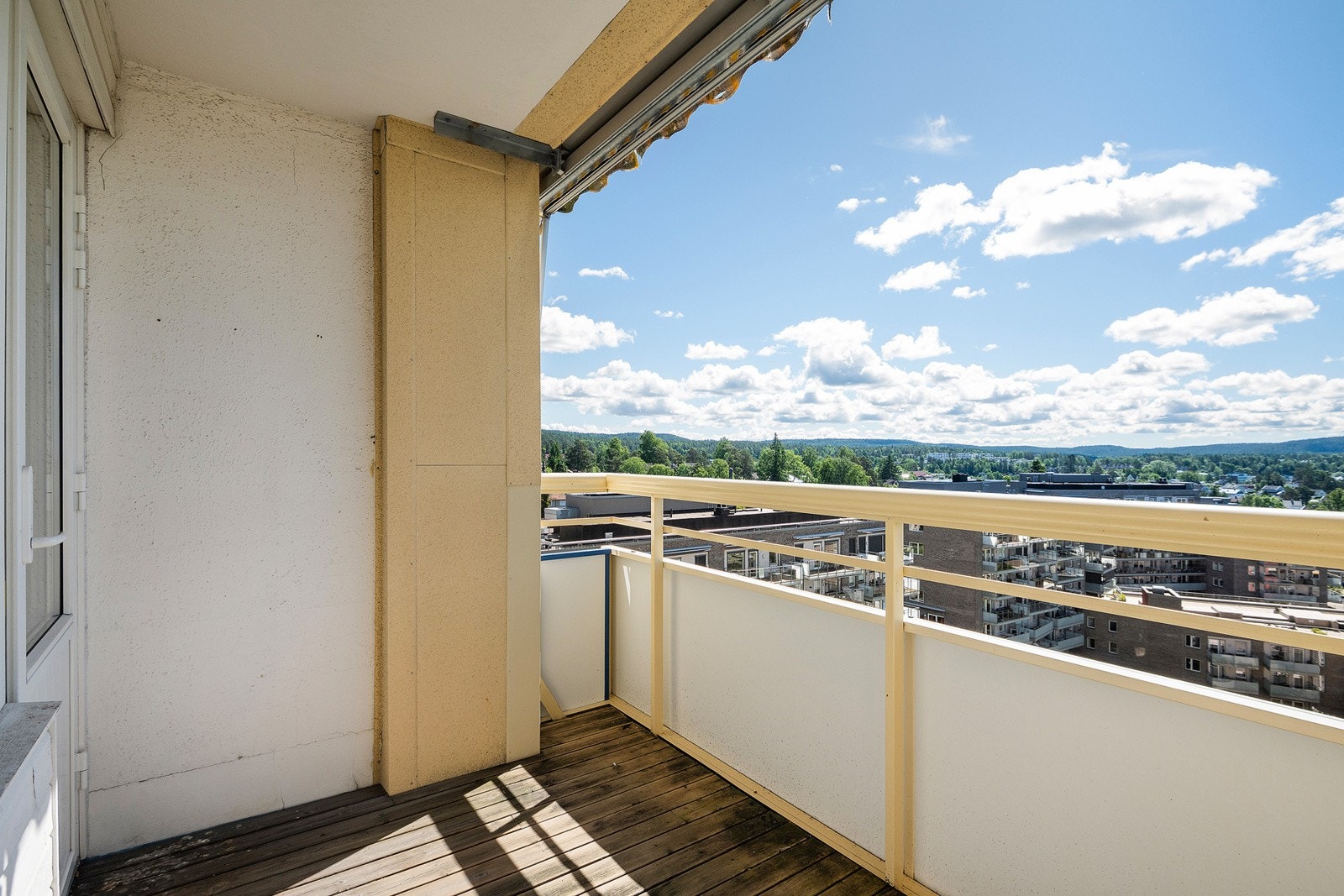 Solrik balkong på 5 m2. Gulvflate belagt med terrassebord. Rømningsluke i gulv. Markise. Galleribilde
