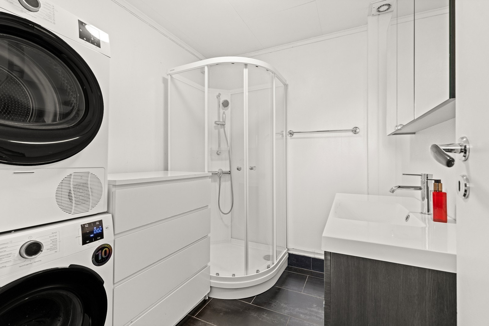 Badet i utleiedelen har fliser, gulvvarme og opplegg for vaskemaskin. Galleribilde
