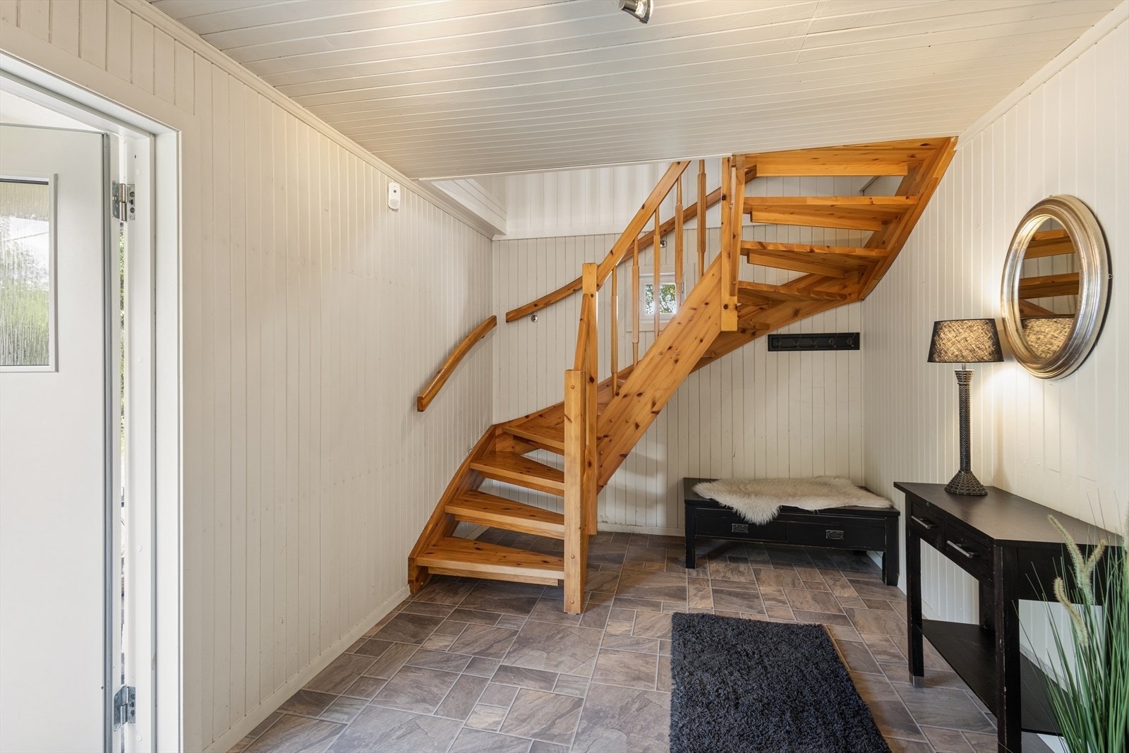 Entreen ønsker velkommen med god plass og en solid tretrapp som leder opp til loftsetasjen. Galleribilde