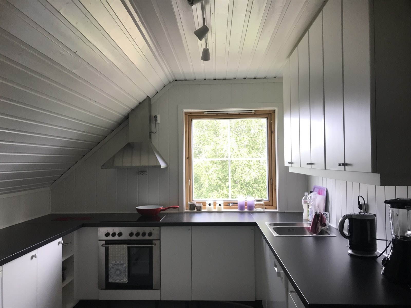 Kjøkkenet i andre etasje har takhøy innredning med glatte fronter. Selgers foto. Galleribilde