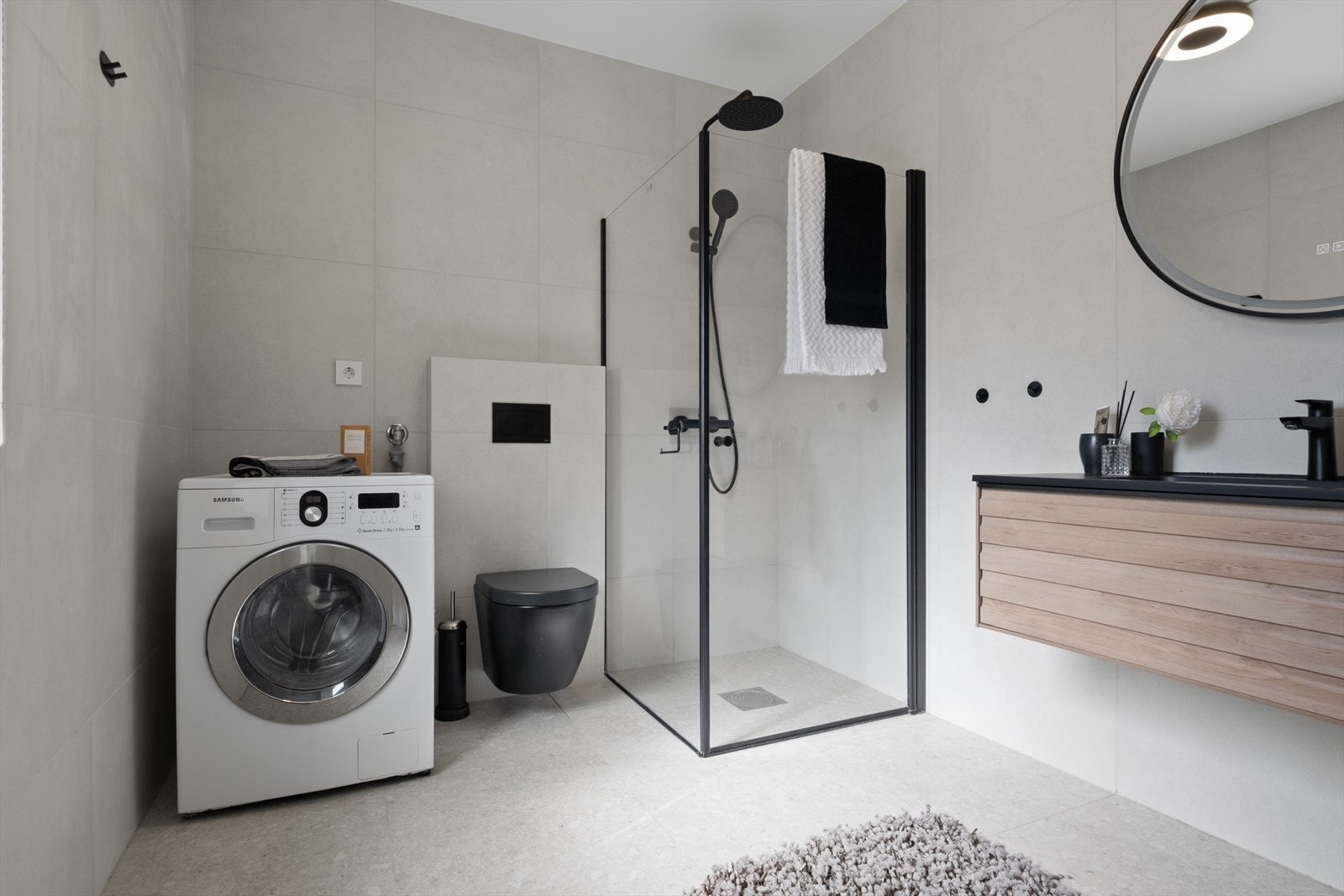 Badet i utleiedelen er helfliset med gulvvarme, dusj og opplegg for vaskemaskin. Galleribilde