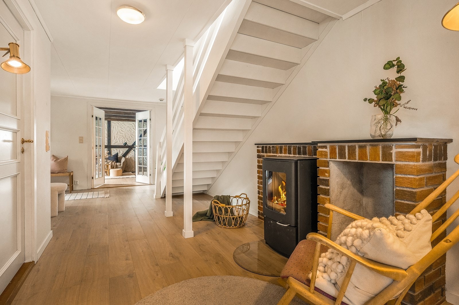 Hallen i underetasjen har nyere laminatgulv og en peisovn som avgir god varme. En yndet leseplass på kalde høstkvelder. Galleribilde