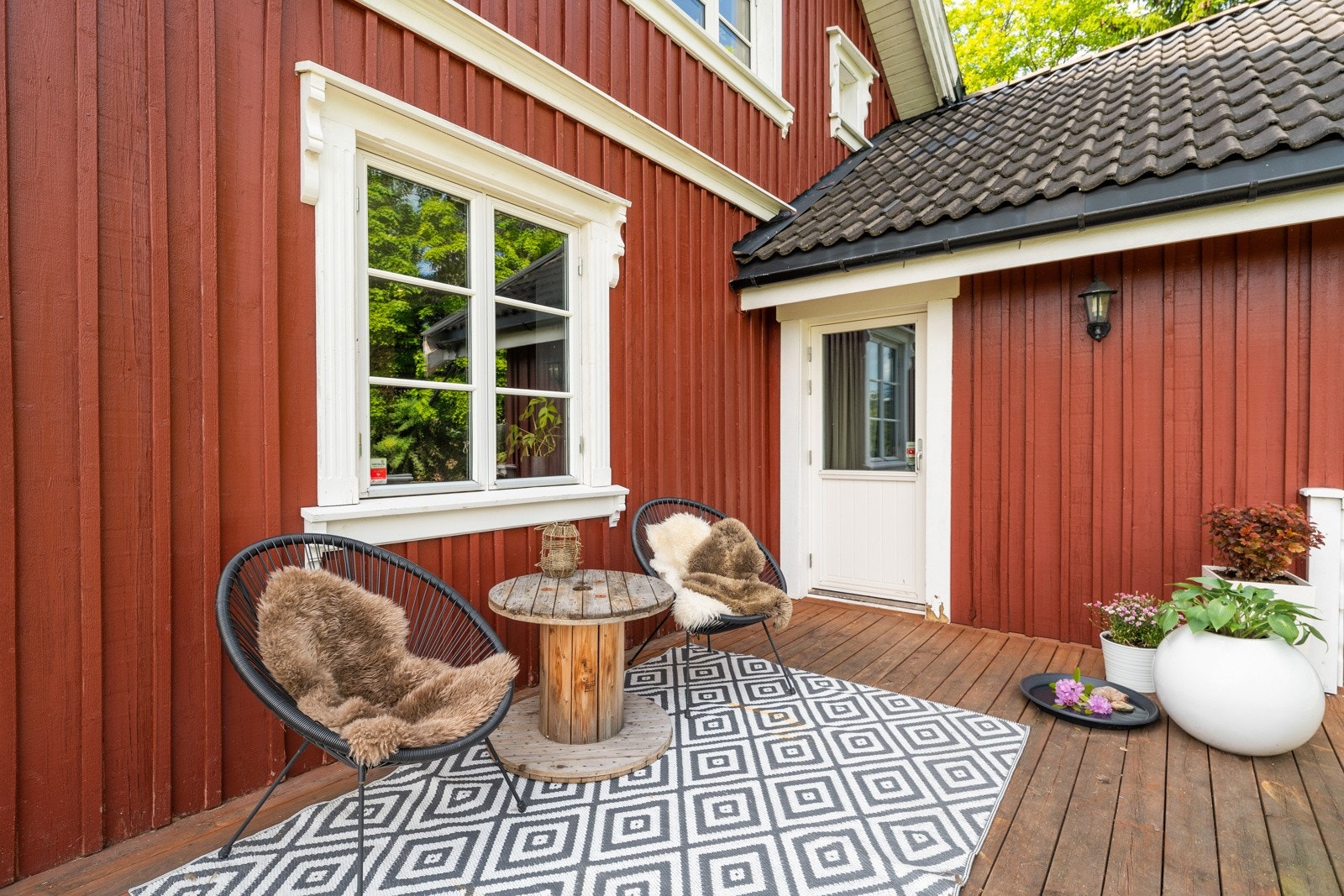 Hyggelig, skjermet terrasse på baksiden av huset med morgensol Galleribilde
