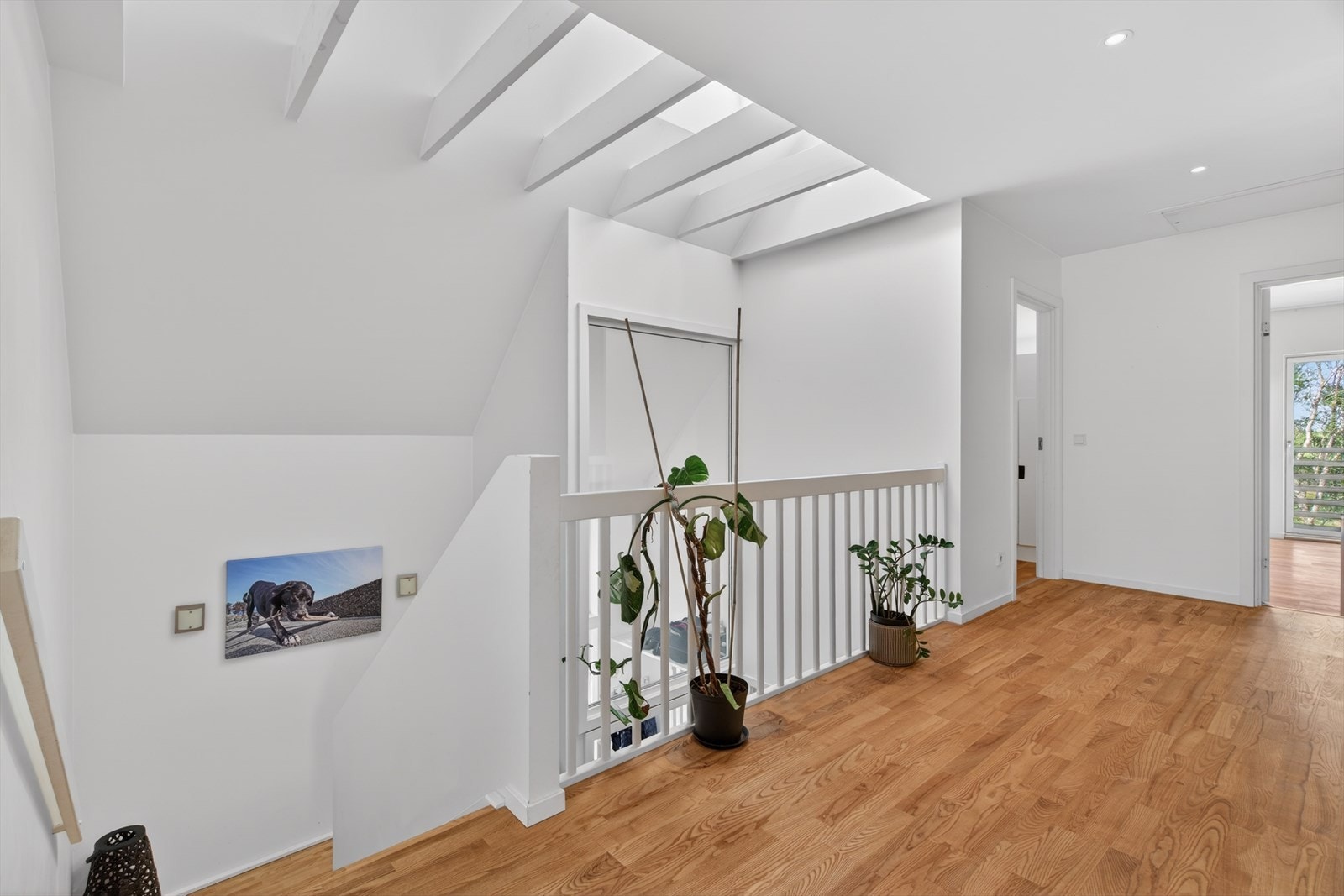 Lys og åpen gang i andre etasje som fordeler til fire soverom og ett bad. Galleribilde