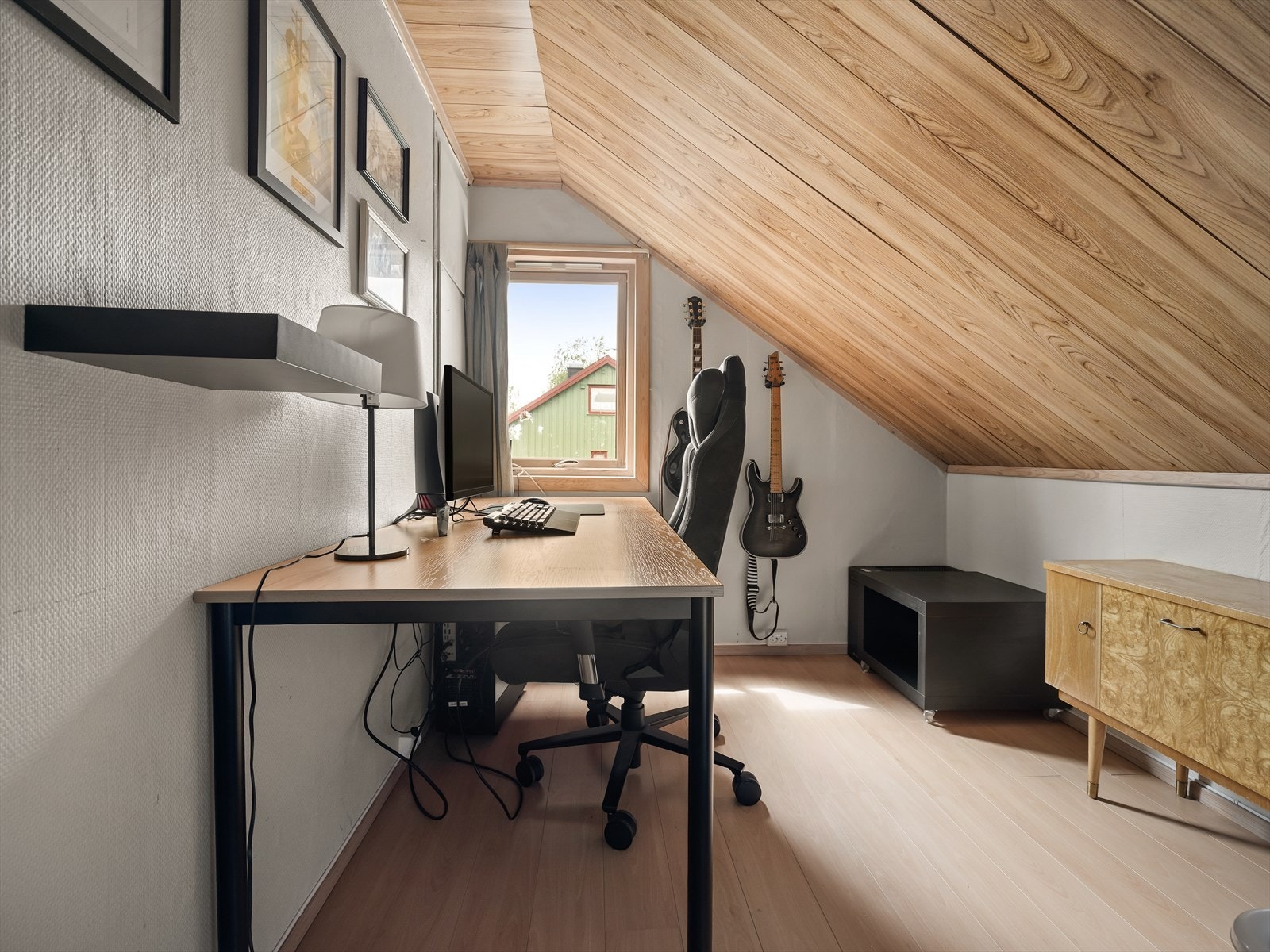 Kontor/soverom med trepanel i himling og på deler av veggen. Galleribilde