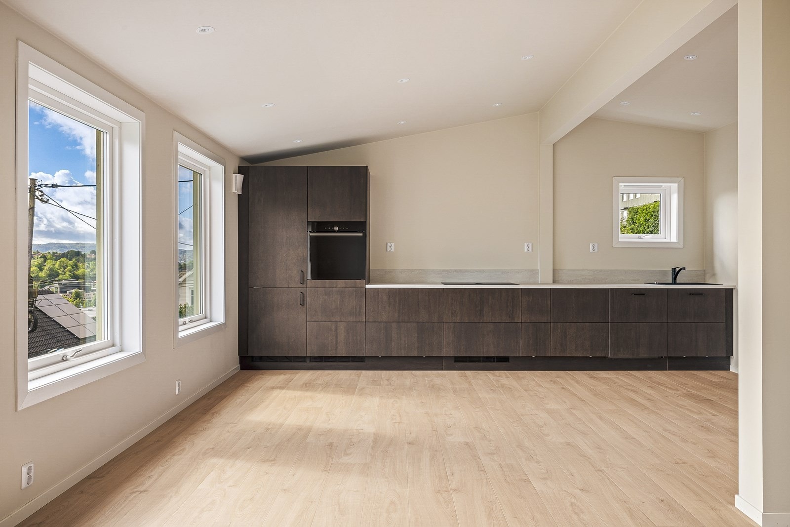 Kjøkkenet er en naturlig del av oppholdsrommet og kombinerer funksjonalitet med moderne design på en elegant måte. Galleribilde