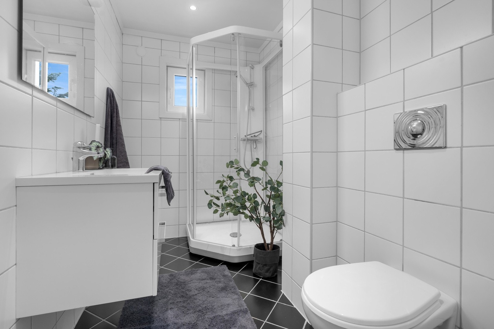 På badet er det blant annet vegghengt toalett, baderomsinnredning og dusjkabinett Galleribilde
