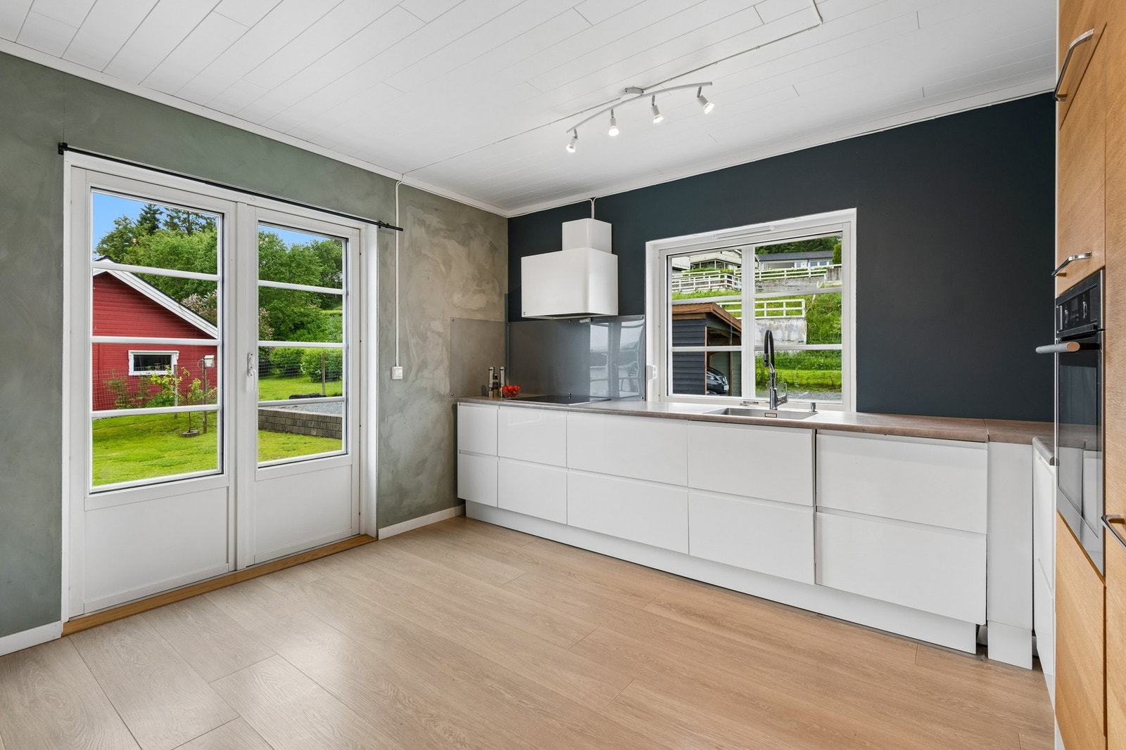 Fra kjøkkenet har man utsikt mot hagen og enkel adkomst til veranda. Galleribilde