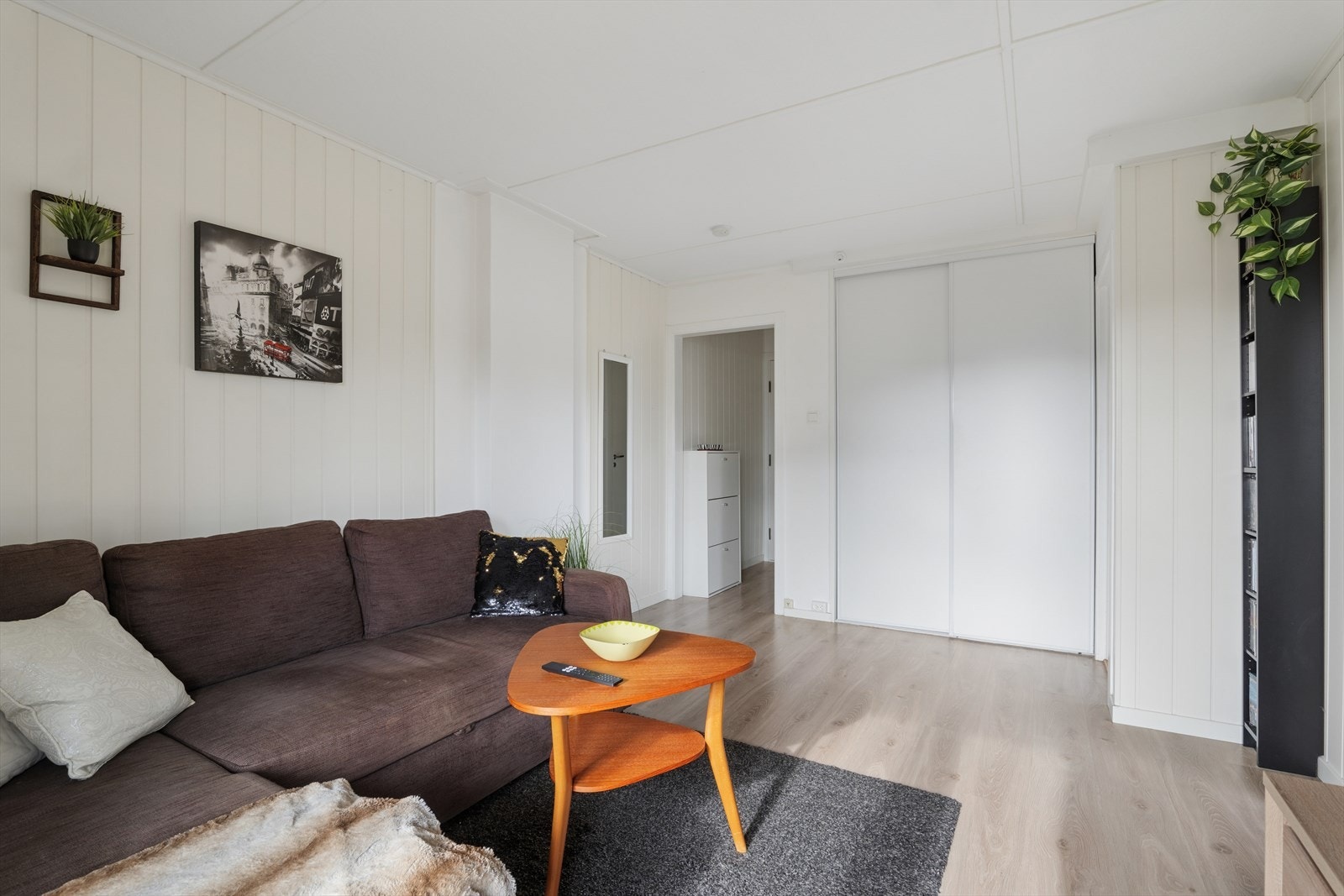 I stue finner man skyvedørsgarderobe som byr på godt med oppbevaringsplass Galleribilde