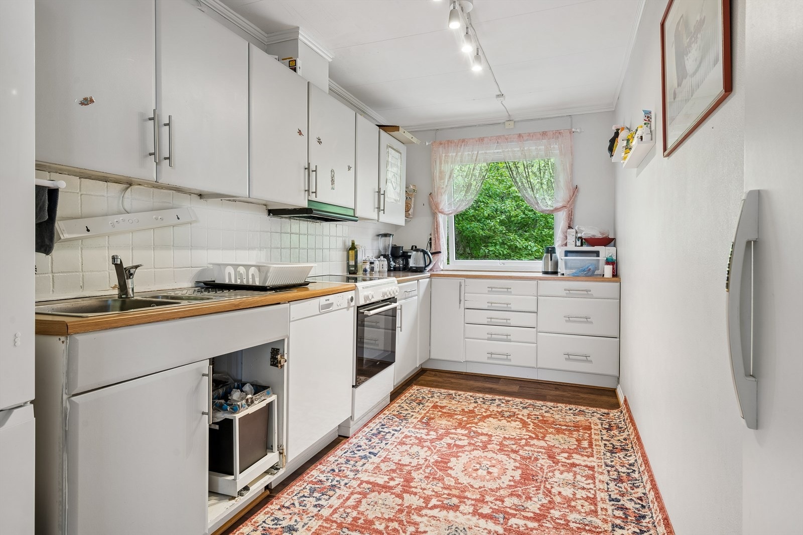 Kjøkkenet har slette fronter og laminert benkeplate med nedfelt vask i stål. Galleribilde