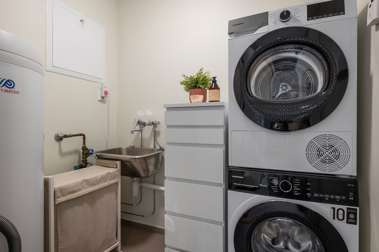 Praktisk vaskerom med opplegg for vaskemaskin og egen vask. Galleribilde