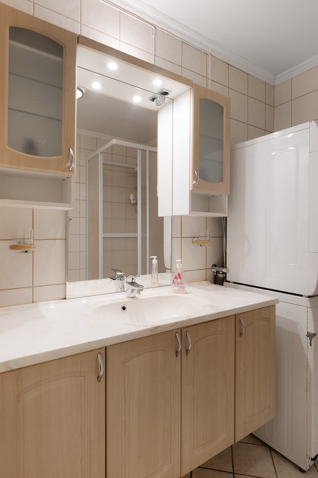 Det er varme i gulvet på badet. Innredning med servant, speil og overskap. Galleribilde