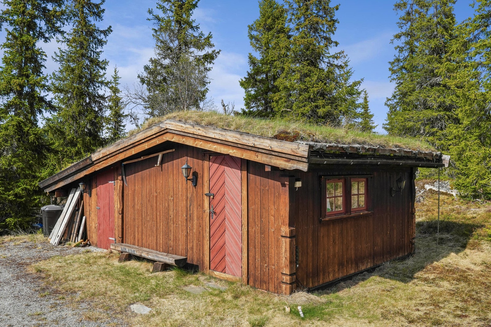 Eiendommen har også praktisk uthus. her er det vedskåle og rikelig med bodplass for lagring og oppbevaring. Galleribilde