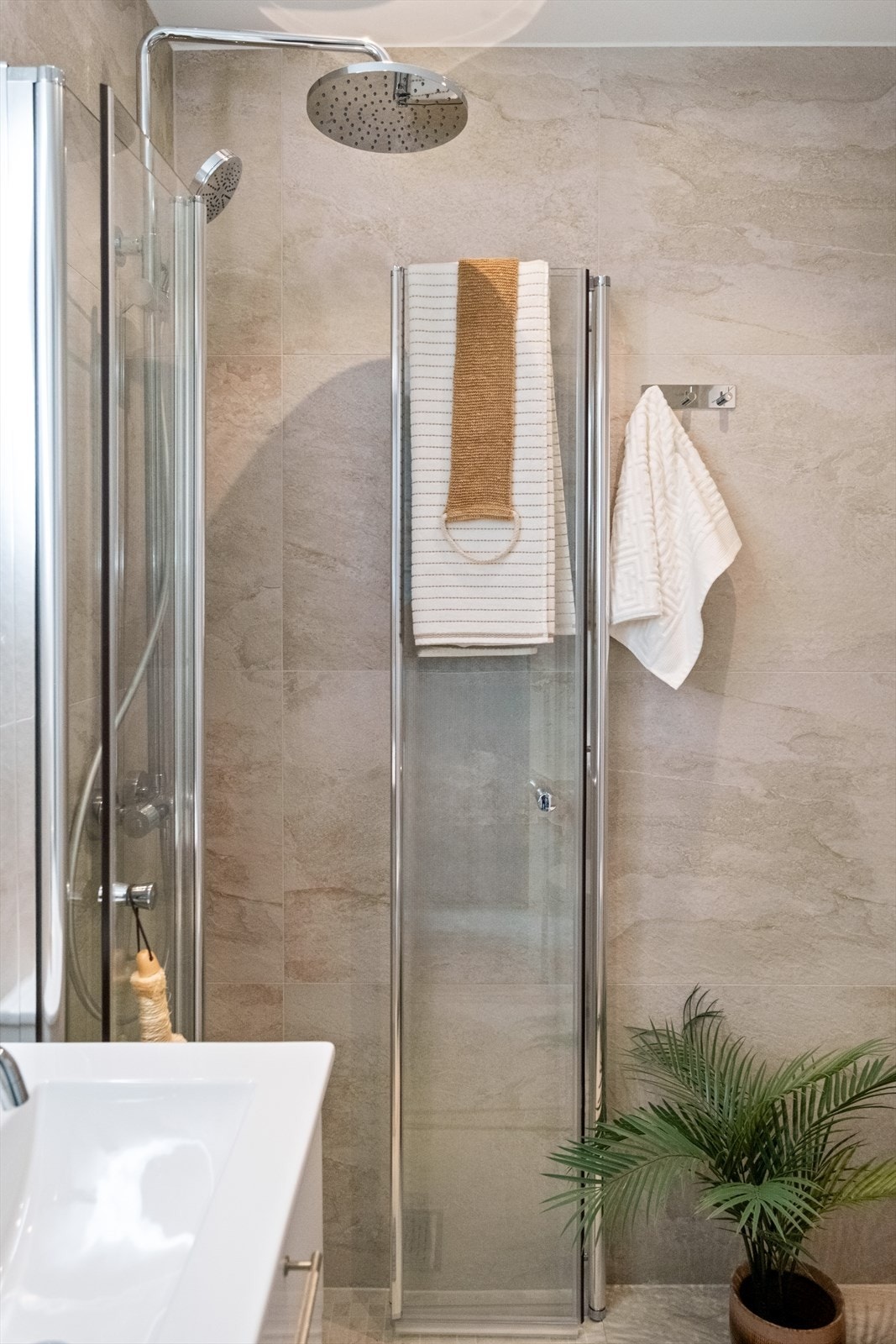 Badet har moderne fliser og fremstår meget innbydende Galleribilde