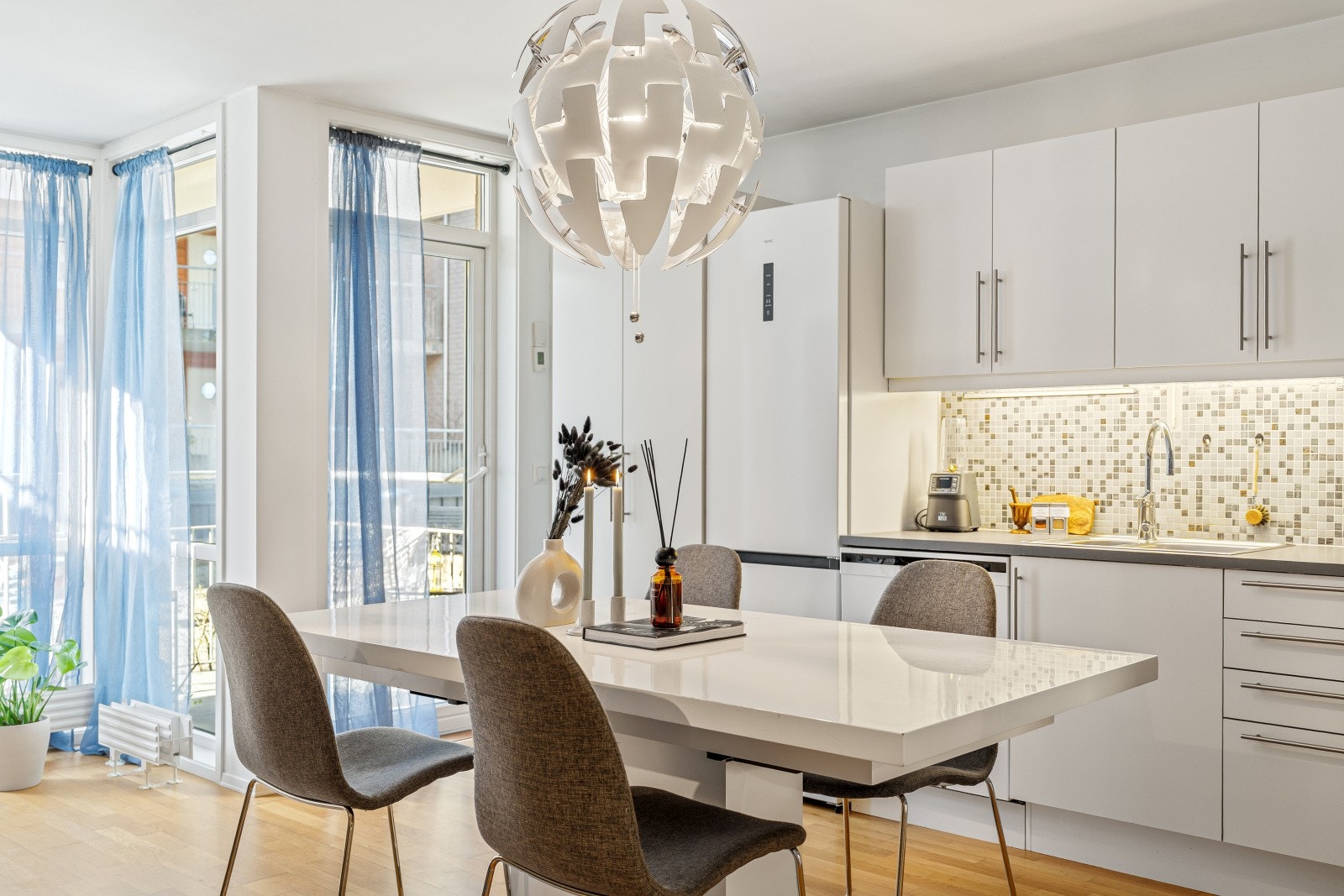 Stuen/kjøkkenet er utstyrt med parkett på gulv og malte plater på vegger, samt flis på vegg over benk ved kjøkkenområdet. Galleribilde