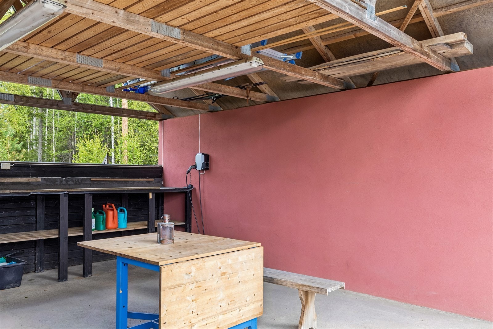 Carporten har medfølgende elbil lader. Når sommerfesten nærmer seg har carporten blitt pyntet og brukt som et "lysthus" med langbord. Galleribilde