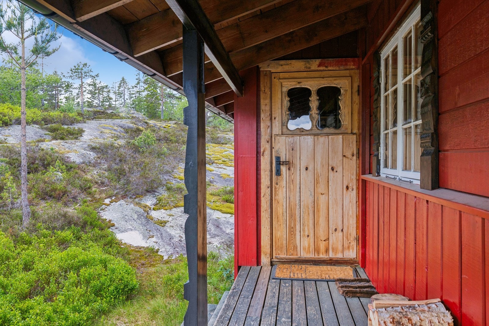 Overbygget inngangsparti med utskjæringer og detaljer i tradisjonell Buen-stil. Galleribilde