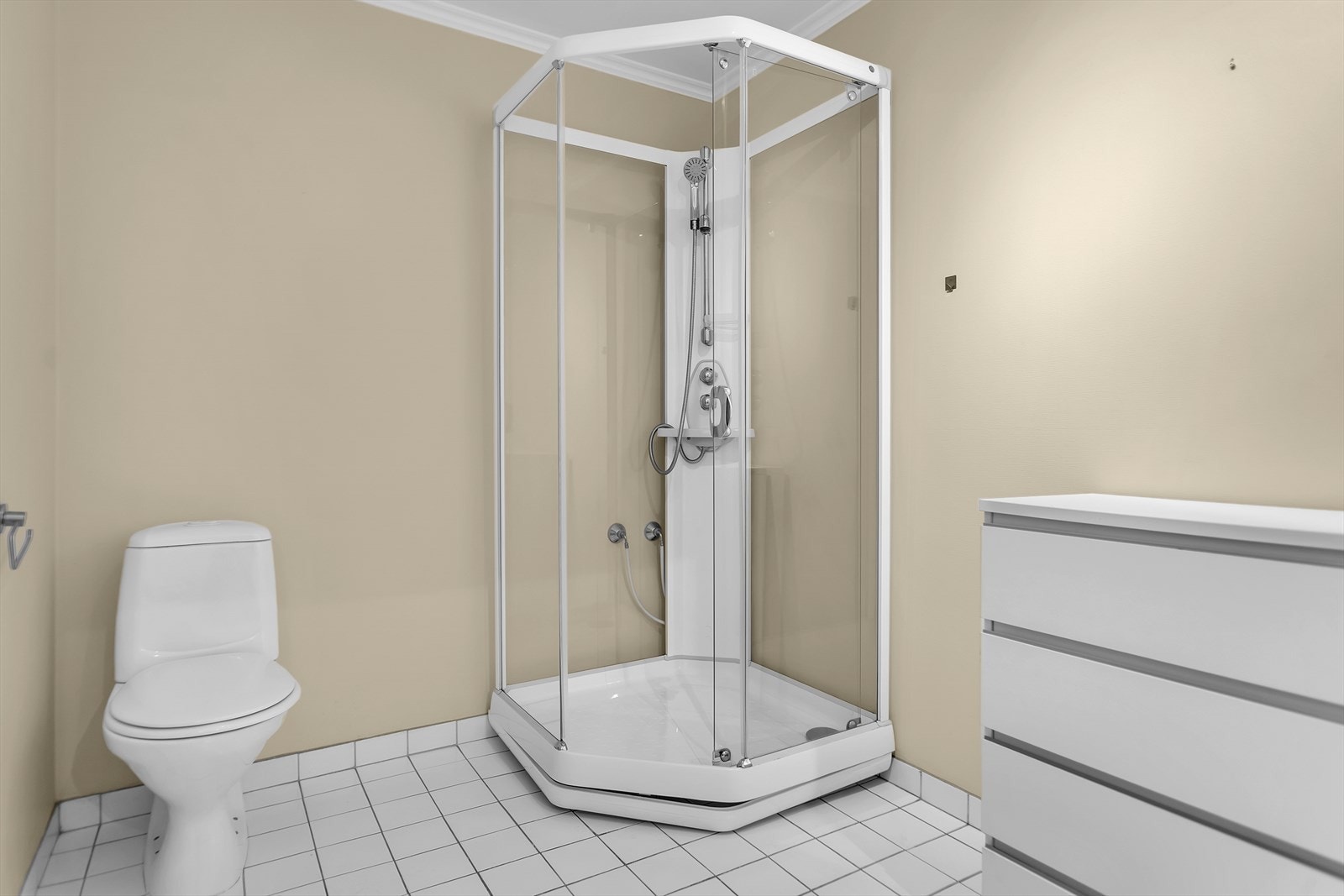 Badet er utstyrt med dusjkabinett, toalett og servantinnredning. Galleribilde