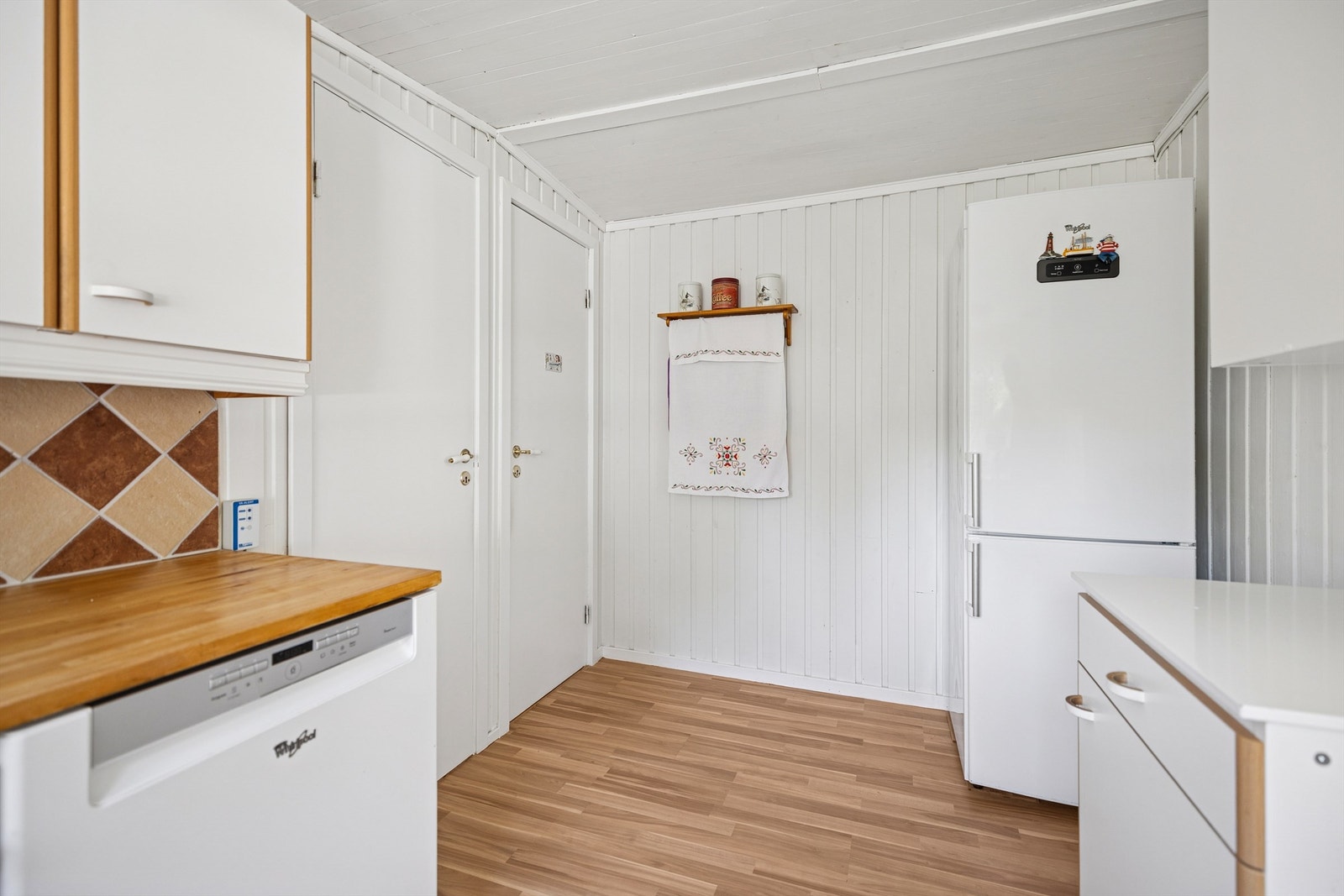 Koselig kjøkken med landlig preg og alt du trenger for hyttekosen. Frittstående kjøleskap, oppvaskmaskin og komfyr med platetopp. Galleribilde