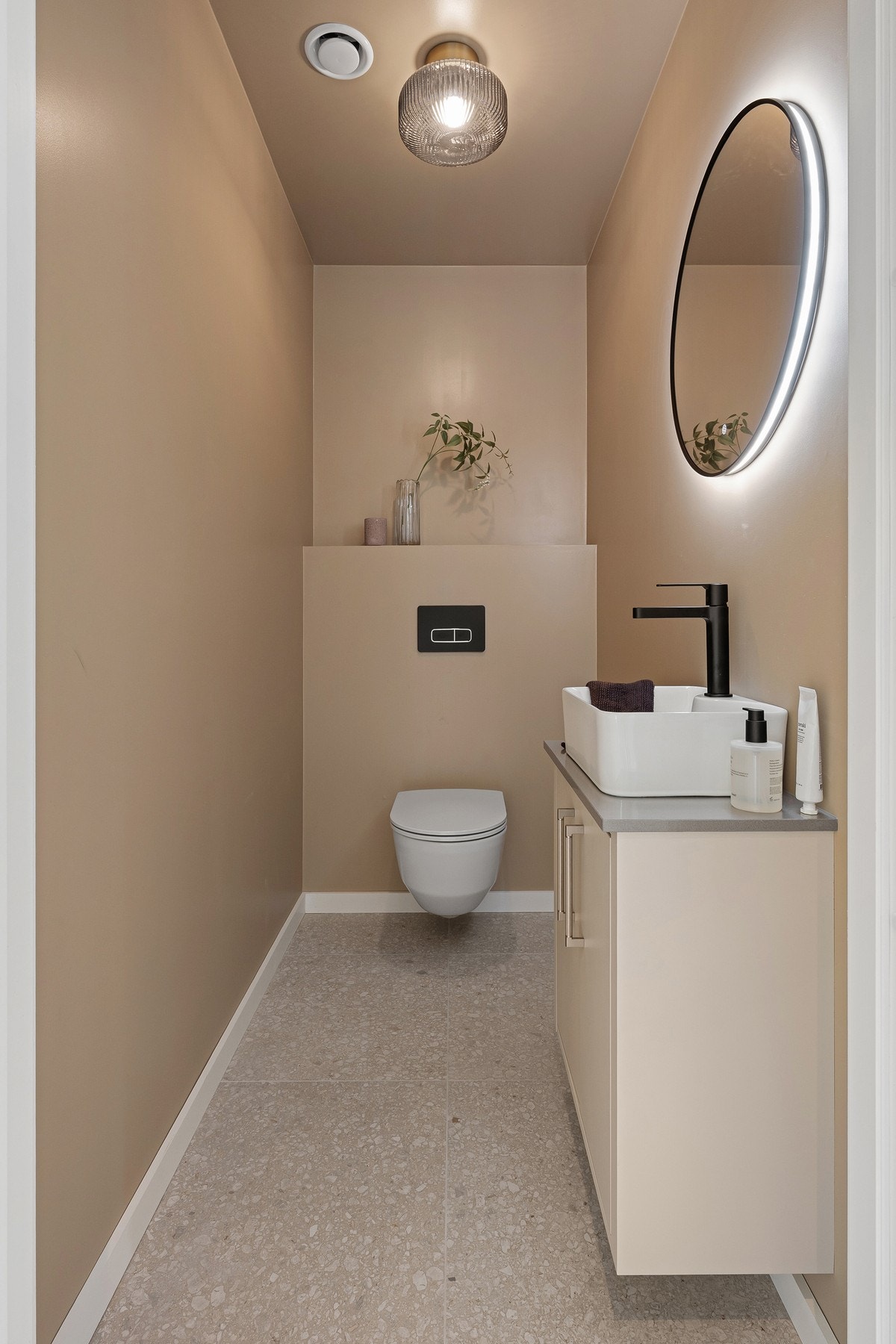 Separat WC i hovedetasjen er en praktisk kvalitet i en familiebolig, med stilrene materialvalg og moderne innredning. Galleribilde