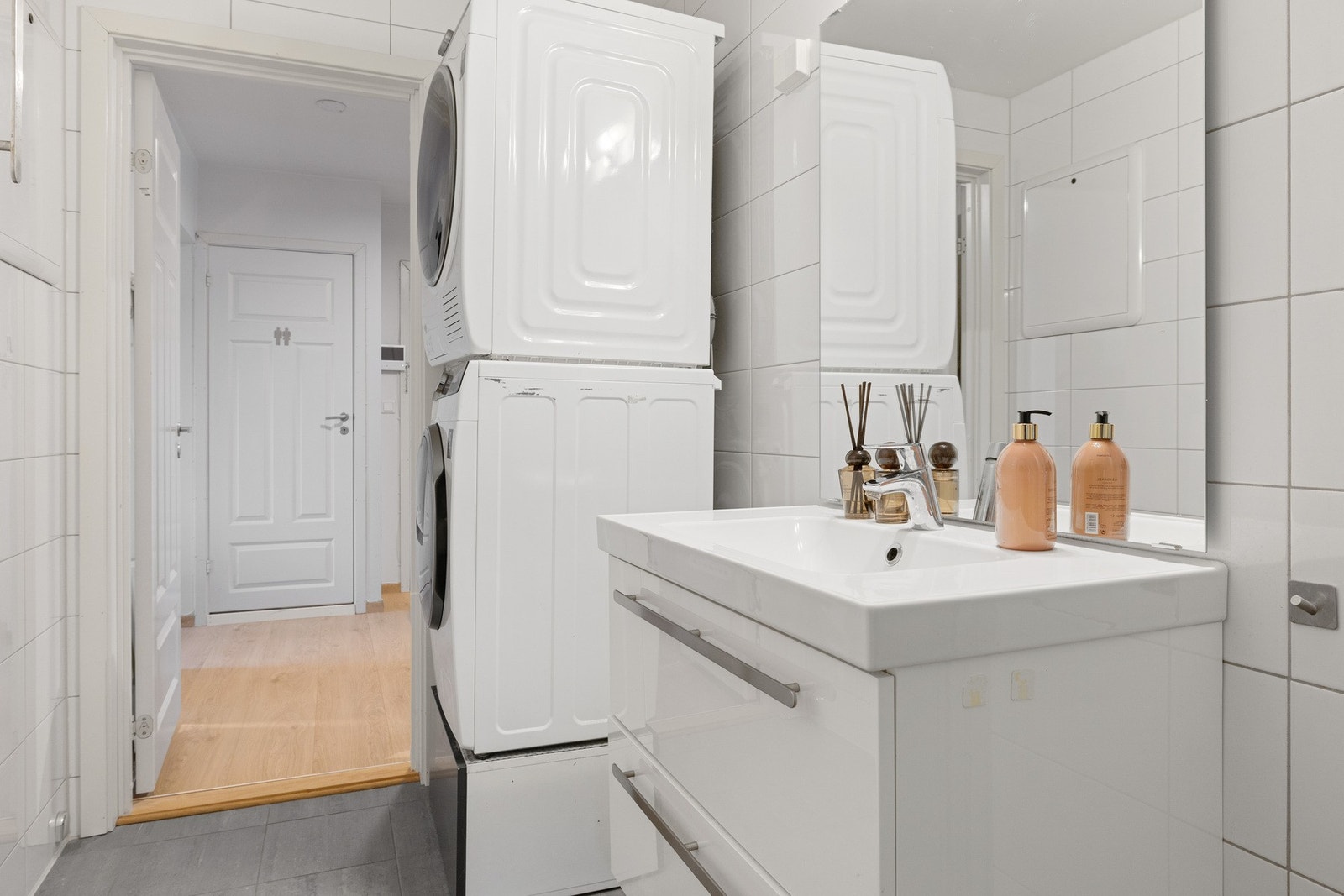 Badet er innredet med en romslig servant med praktiske skuffer, samt god plass til både vaskemaskin og tørketrommel. Galleribilde