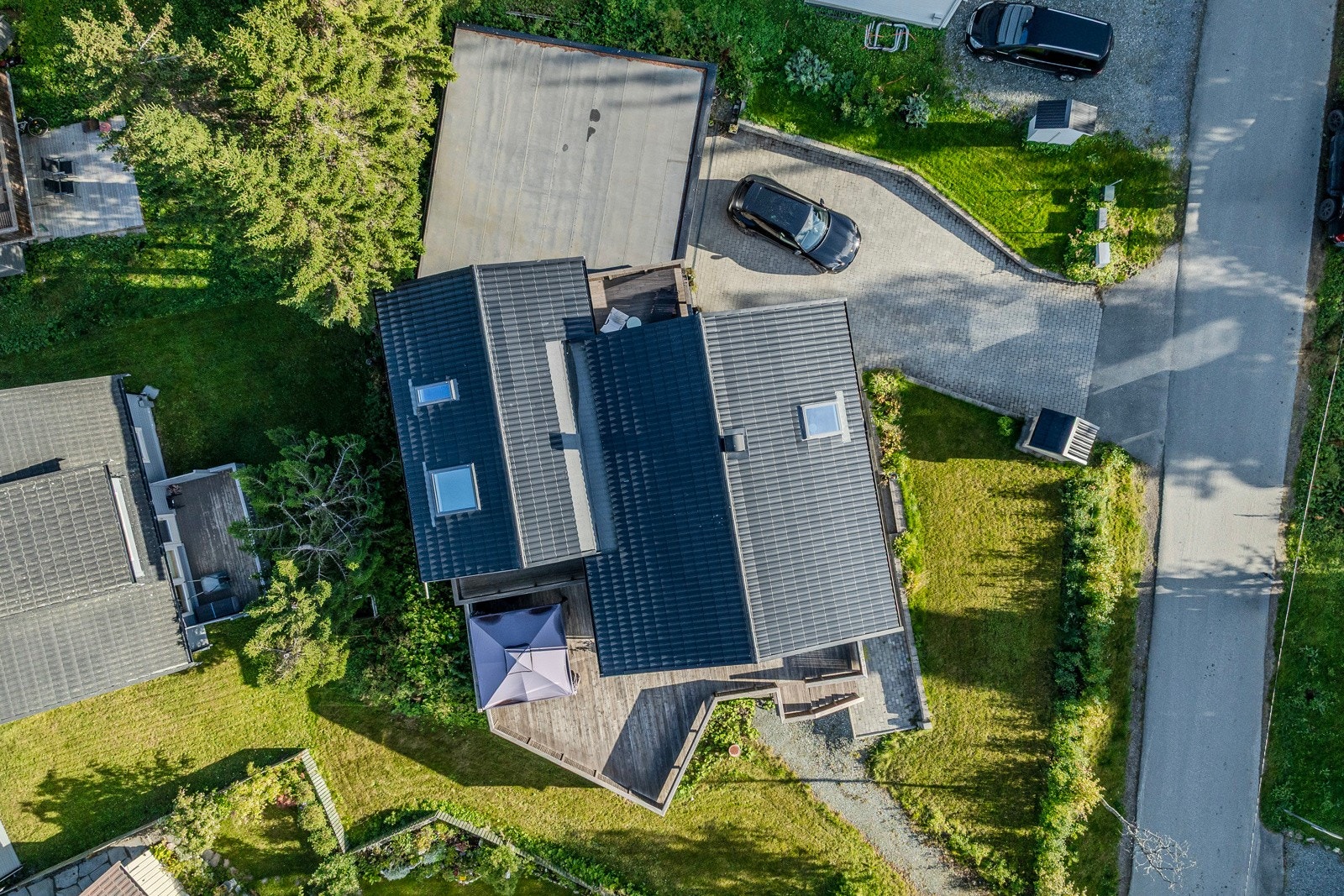 Hagen er pent opparbeidet med plen og diverse beplantning, perfekt for uteaktiviteter som lek eller trampoline.