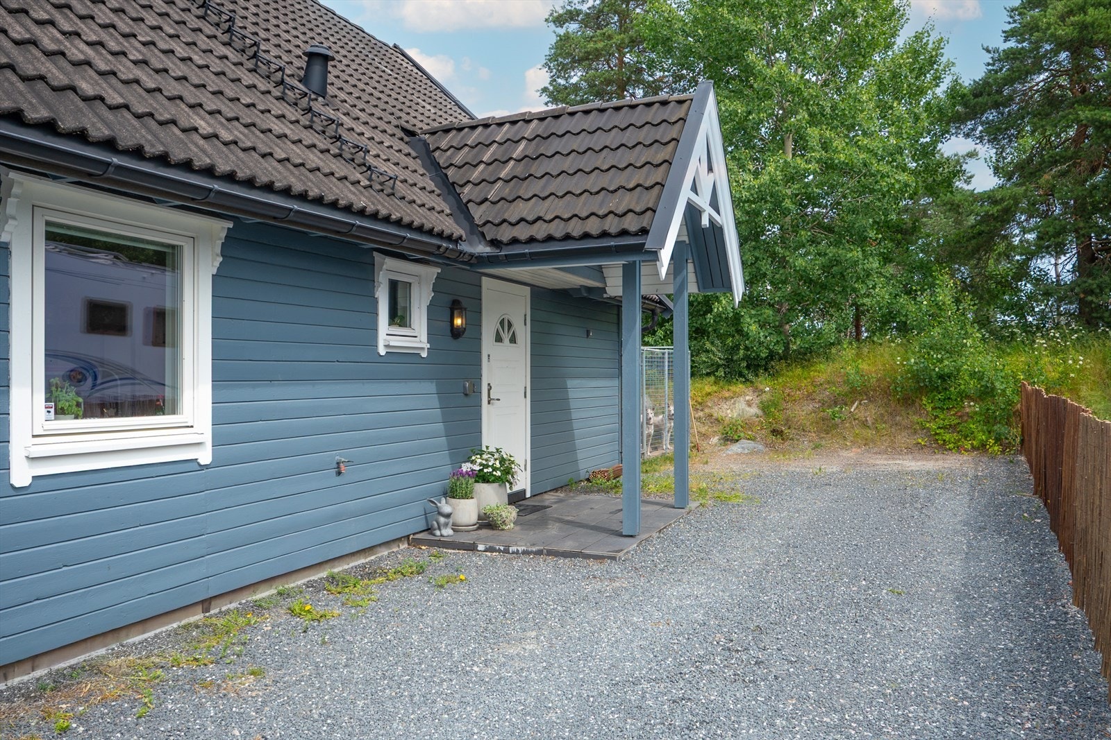 Fra garasjen er det kort vei til boligens steinlagte og overbygde inngangsparti. Galleribilde