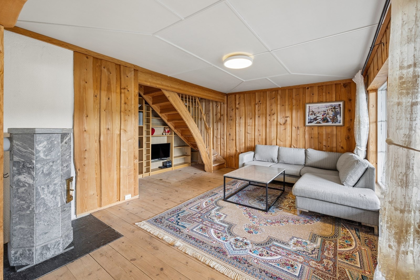 En av boligens to ildsteder er plassert i stuen og bidrar med varme og hygge. Galleribilde