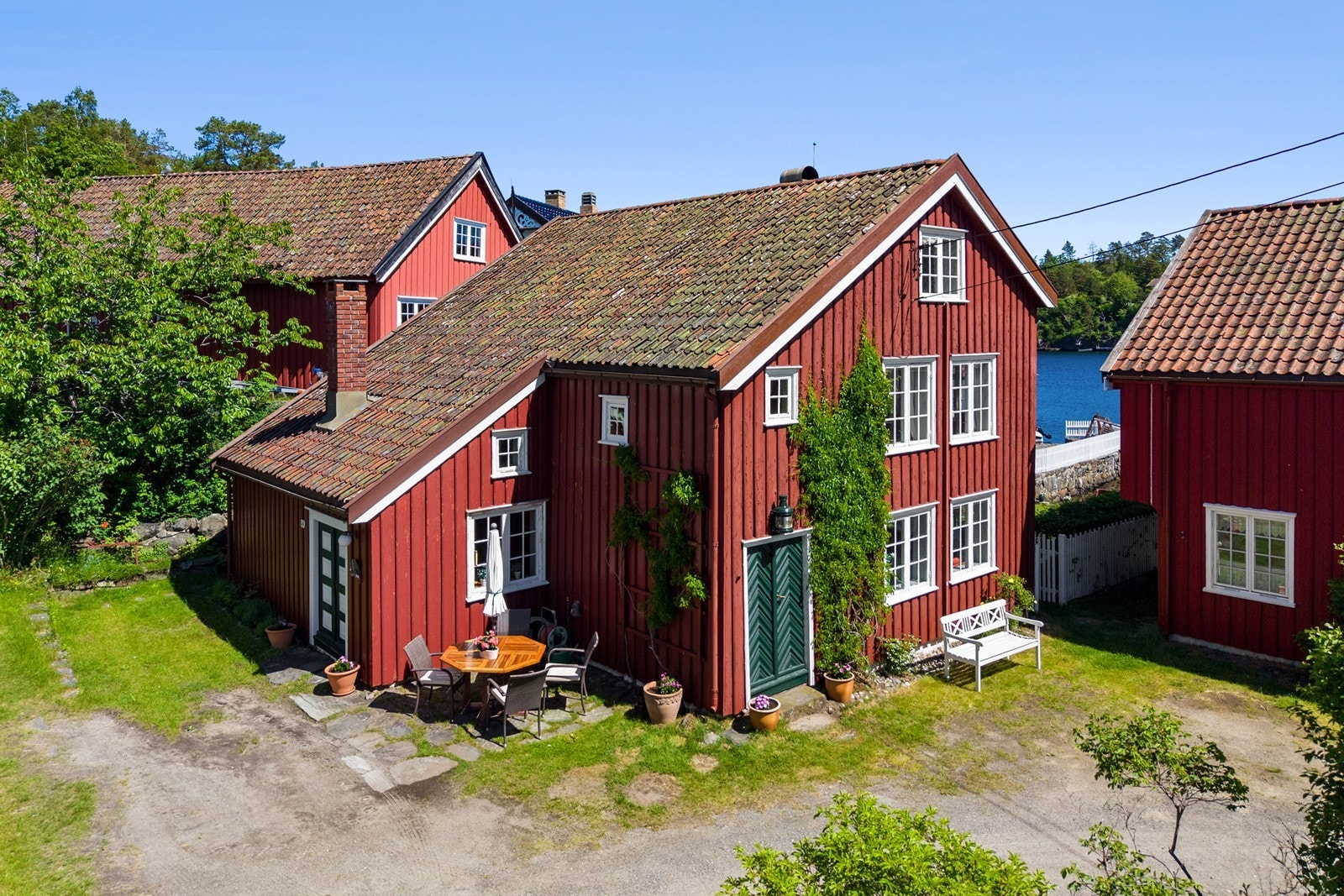 Tunet er opparbeidet med plen og hyggelig steinsatt terrasse Galleribilde